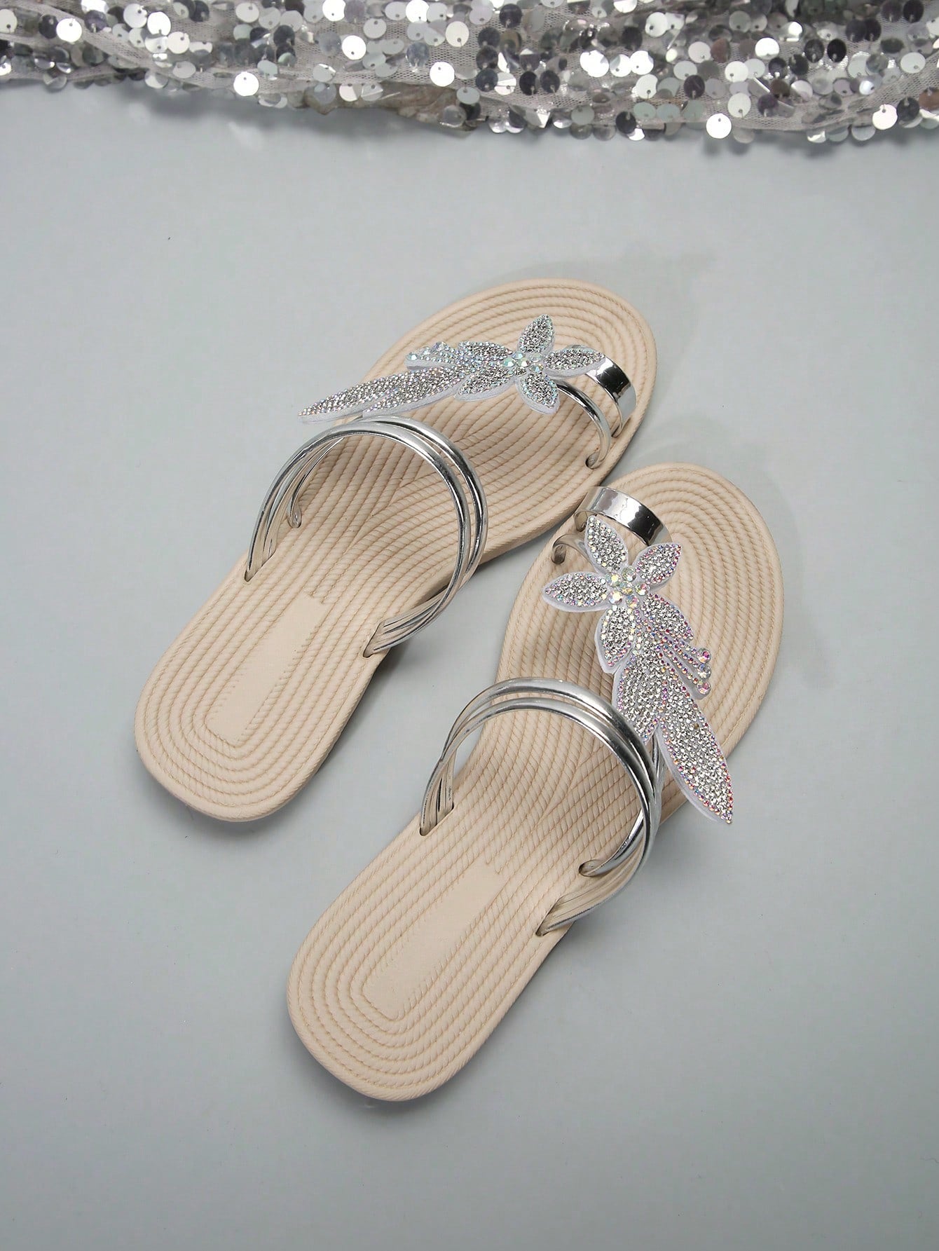 Women's flat slide sandals with crystal-style rhinestone and bow embellishments, toe post front, and beach-ready slip-on design.