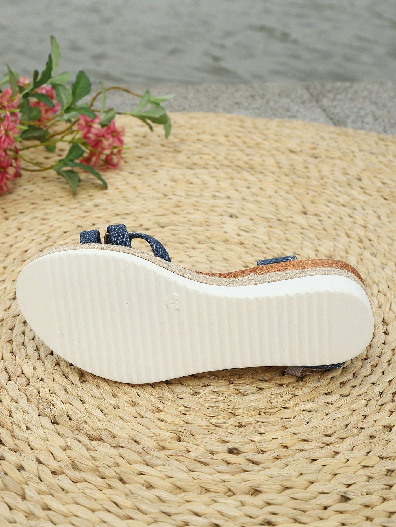 Women’s open-toe wedge sandals with a woven platform-style sole, ankle buckle strap, and mid heel, shown in a casual outdoor style.