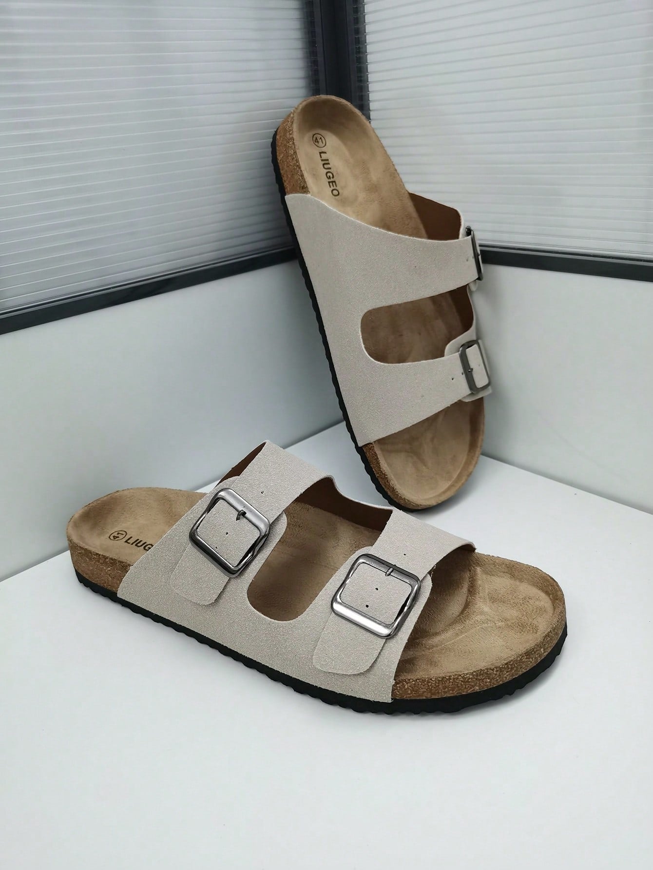 Open-toe footbed slip-on mule sandals with buckle detail and cork-style sole, flat heel design for casual summer home and outdoor walking.