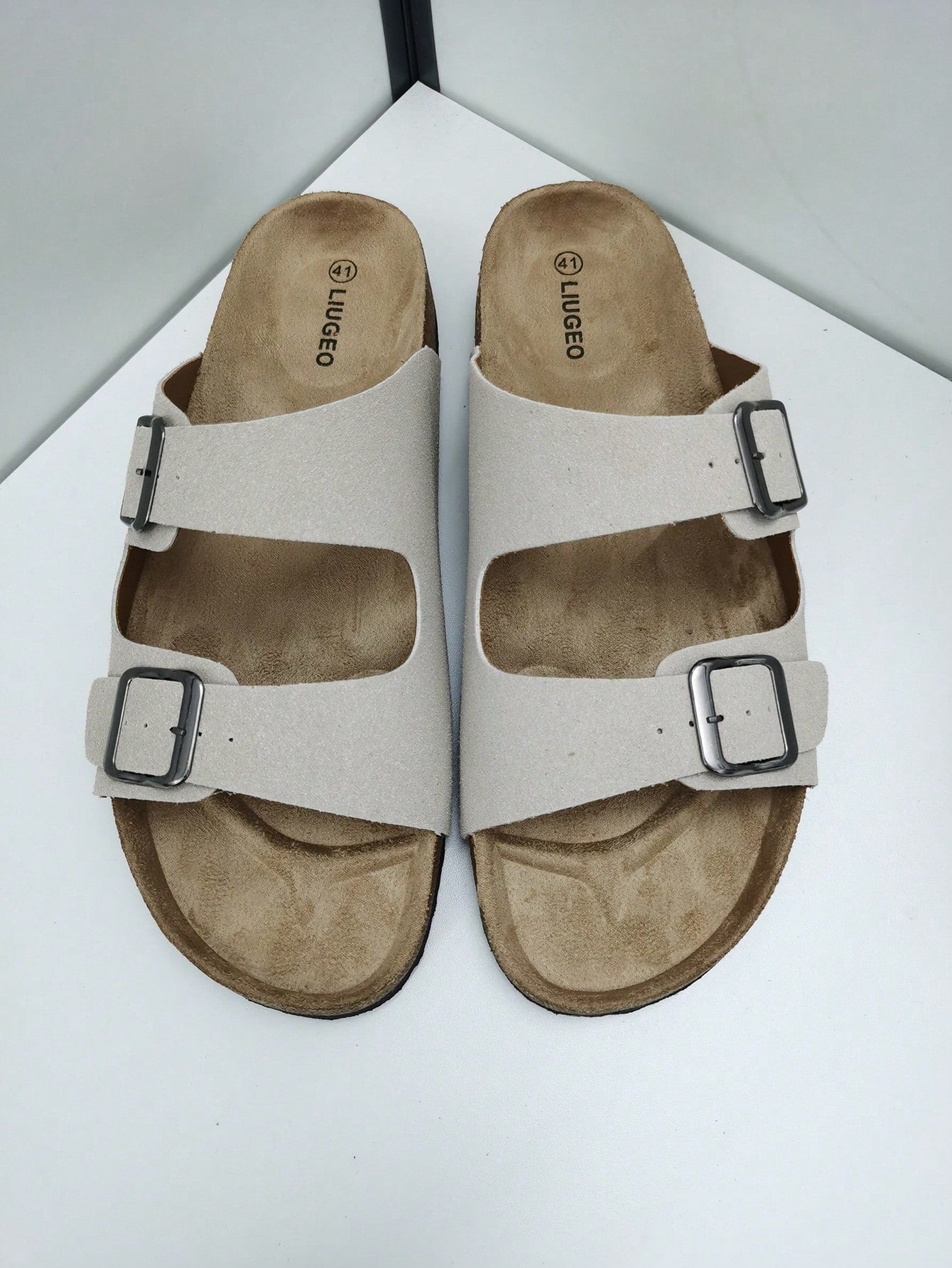 Open-toe footbed slip-on mule sandals with buckle detail and cork-style sole, flat heel design for casual summer home and outdoor walking.