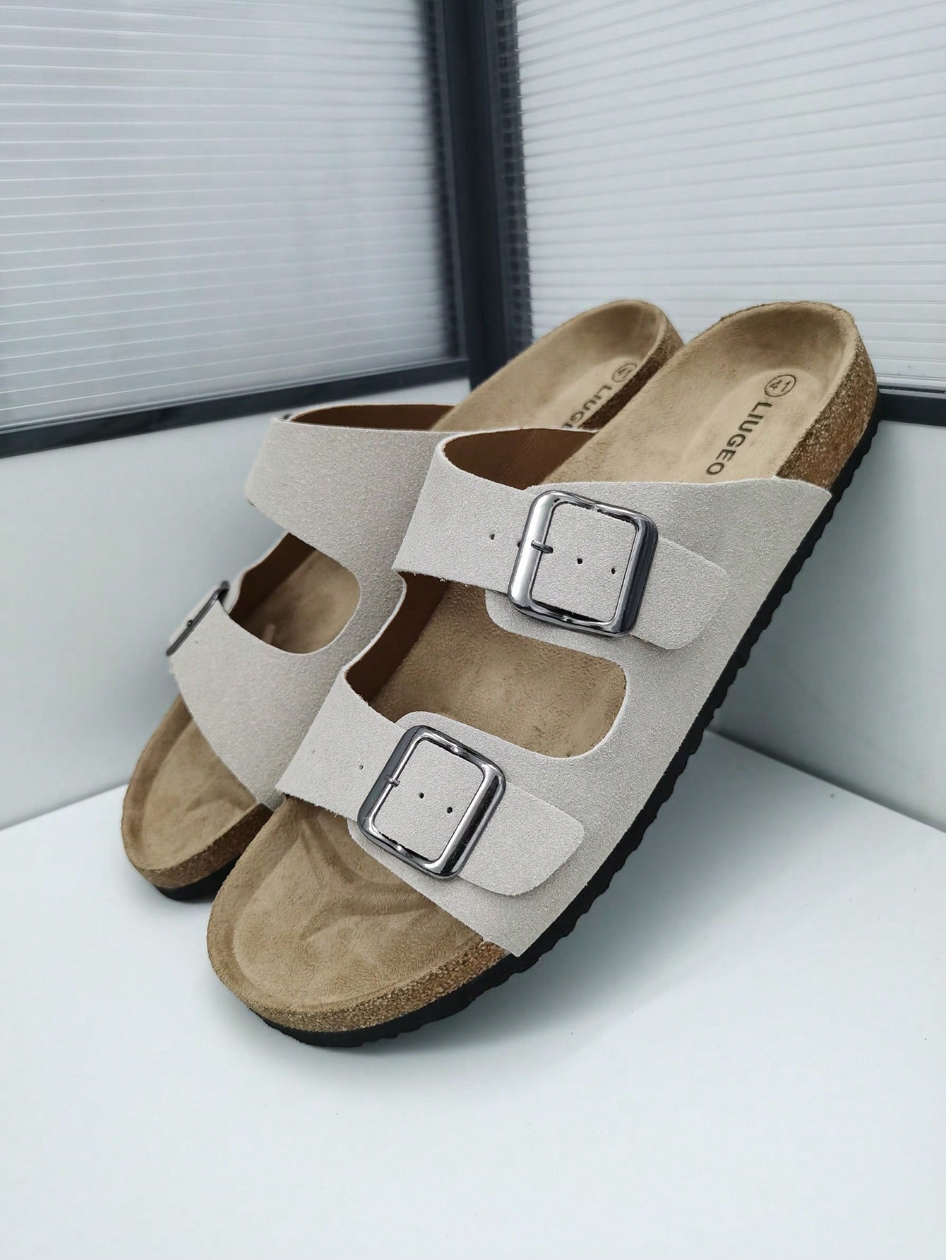 Open-toe footbed slip-on mule sandals with buckle detail and cork-style sole, flat heel design for casual summer home and outdoor walking.