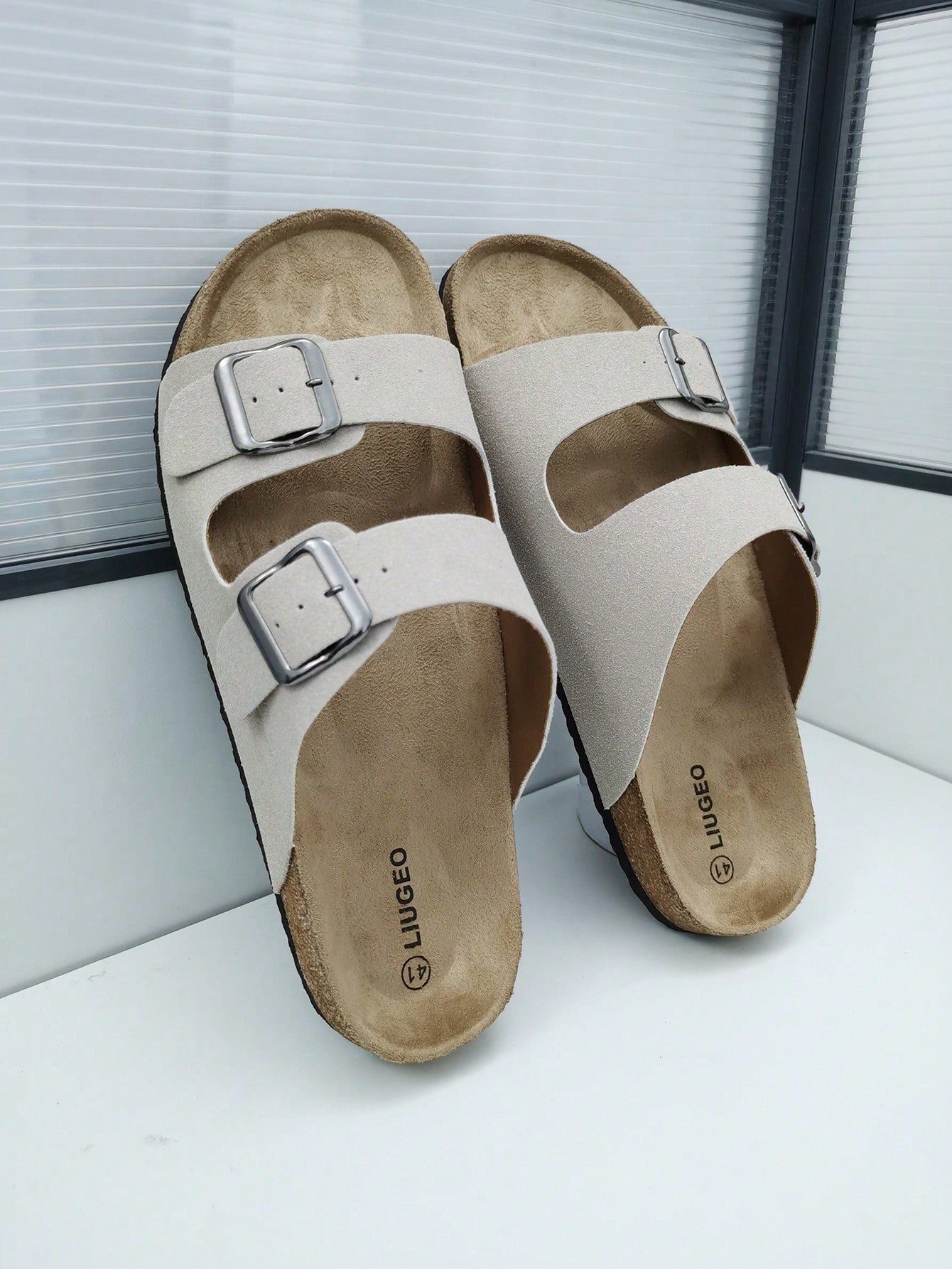 Open-toe footbed slip-on mule sandals with buckle detail and cork-style sole, flat heel design for casual summer home and outdoor walking.