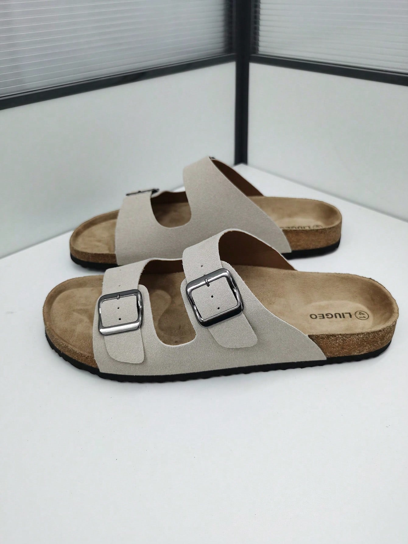 Open-toe footbed slip-on mule sandals with buckle detail and cork-style sole, flat heel design for casual summer home and outdoor walking.