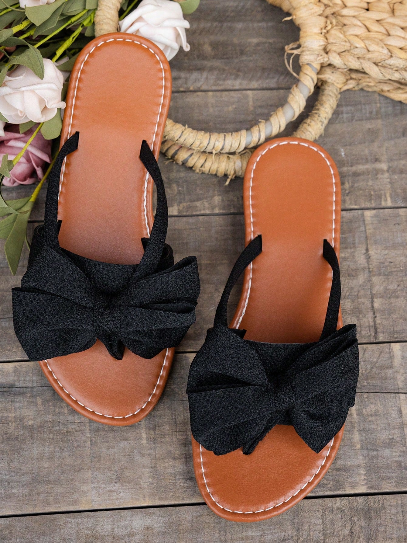 Women's flat bow thong sandals in a casual beach slide style with open toe and tropical pattern.