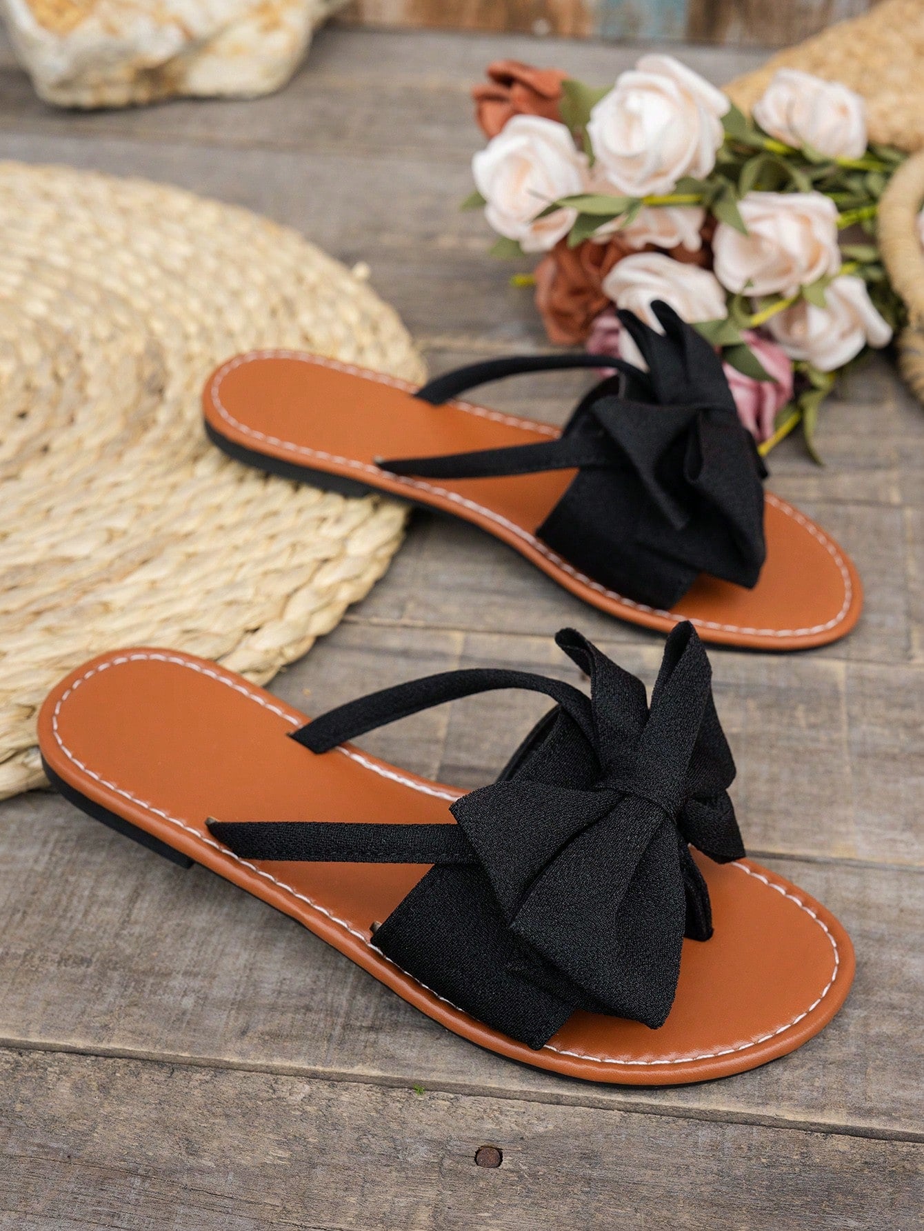 Women's flat bow thong sandals in a casual beach slide style with open toe and tropical pattern.