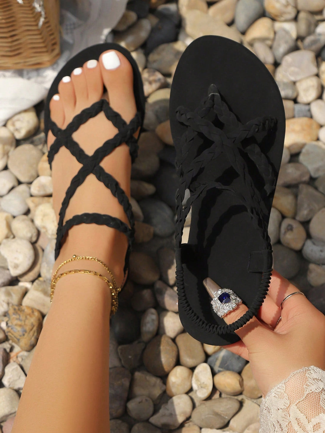 Black women's flat sandals with criss-cross elastic straps, braided detail, toe post, and non-slip sole in a casual beach slide style.