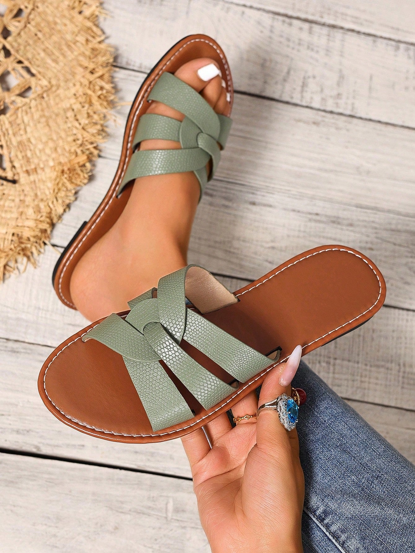 Women’s flat open-toe slide sandals with braided strap detail, embossed texture, and rhinestone decoration, designed as casual slip-on footwear for beach and everyday outdoor wear.