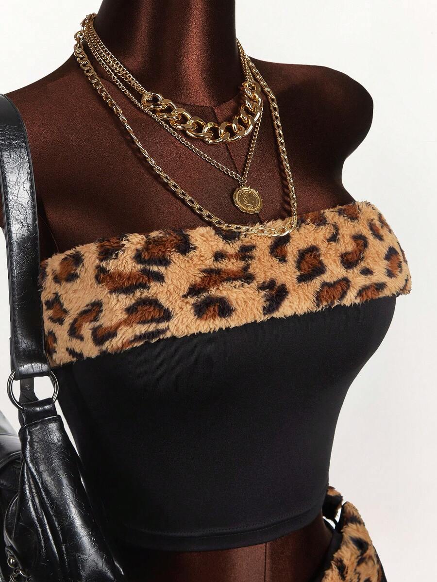 Women's black leopard print two-piece set with strapless bandeau crop top, knot and lace-up details, and matching mini shorts.