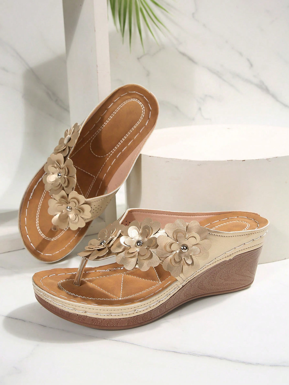 Women's gold platform flip flop wedge sandals with toe post and textured flower detail, slip-on vacation slide style with mid heel.