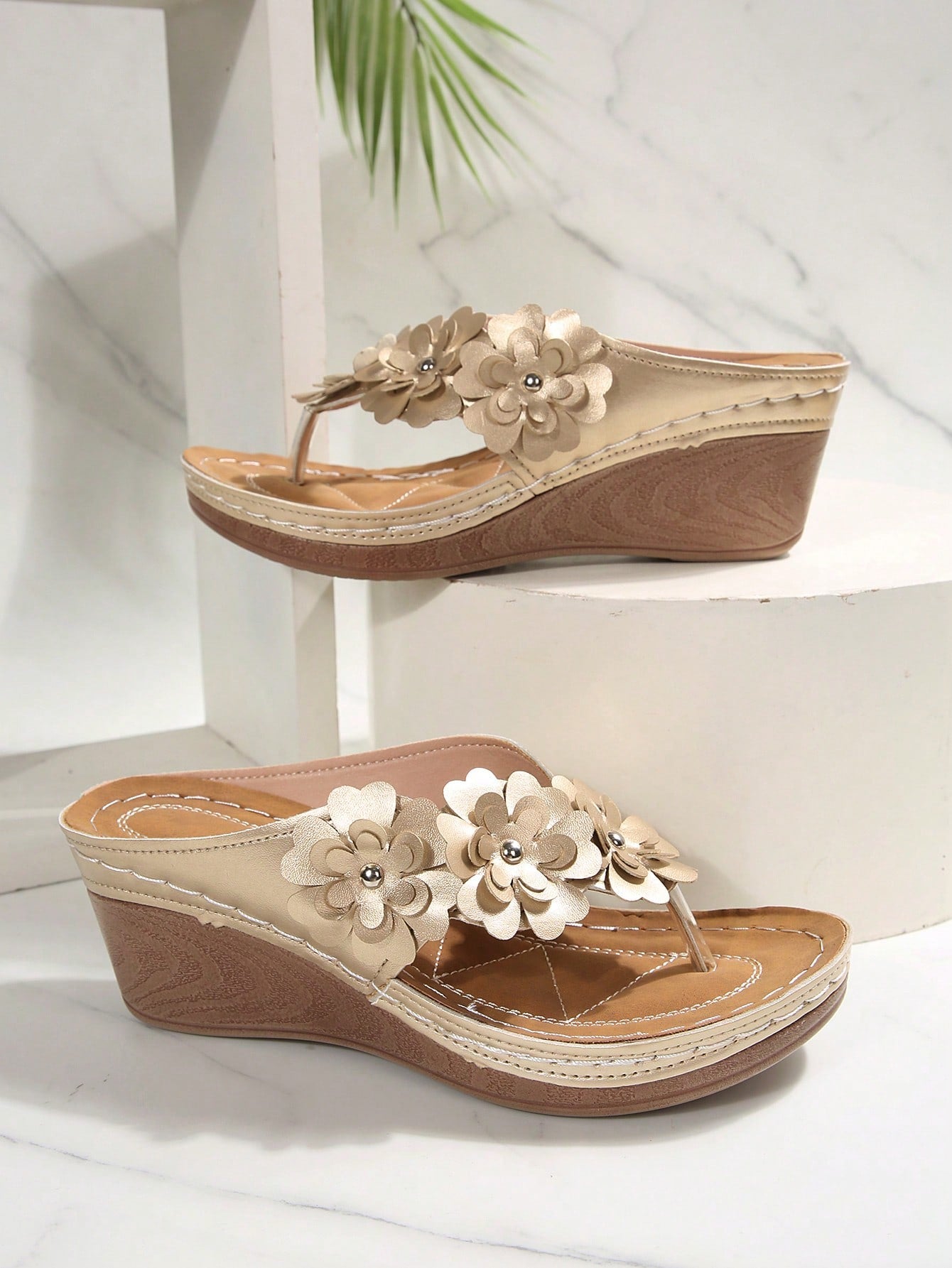 Women's gold platform flip flop wedge sandals with toe post and textured flower detail, slip-on vacation slide style with mid heel.