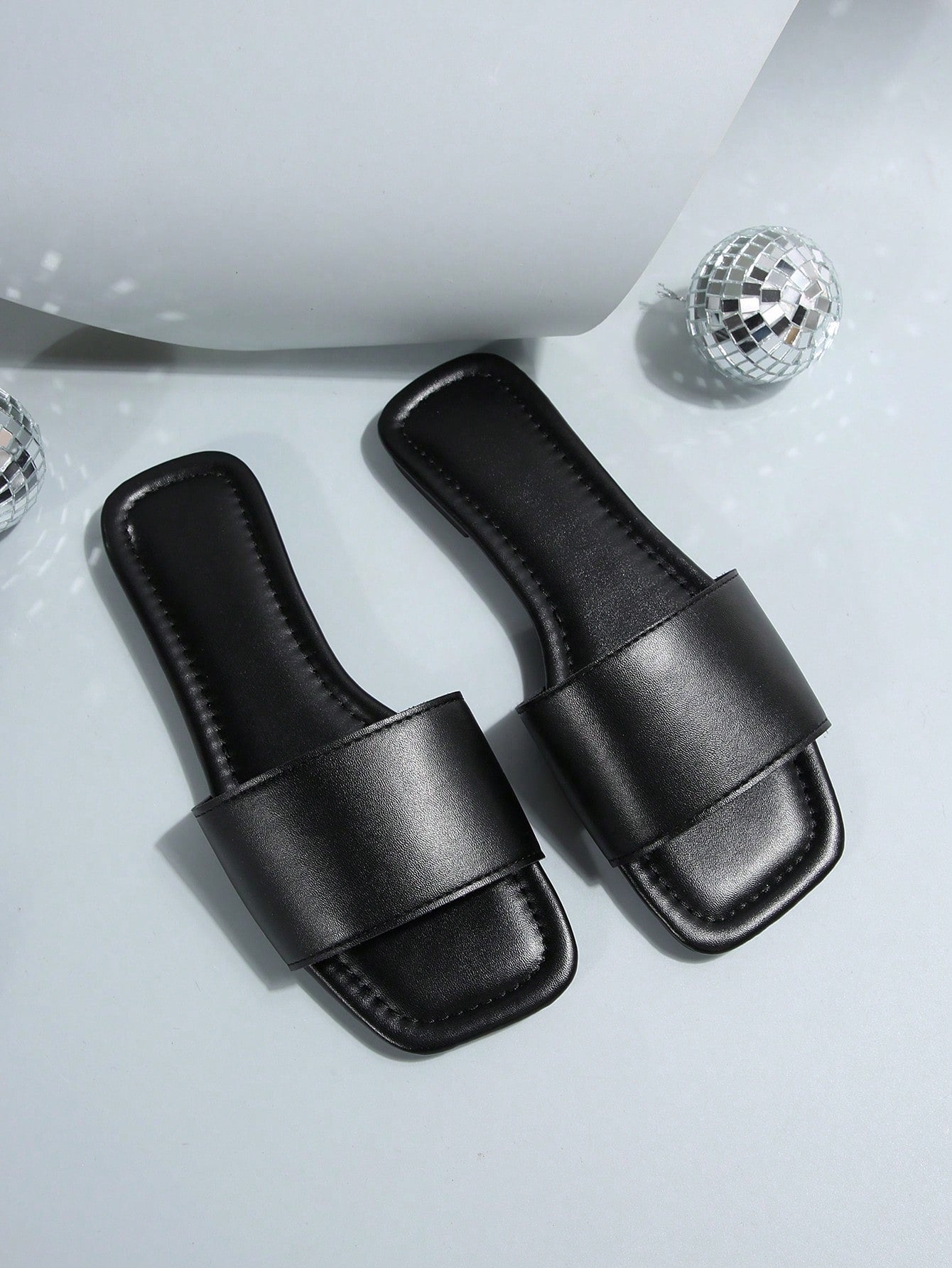 Women's flat slide sandals with a minimalist strap design, square open toe, and slip-on style for casual indoor and outdoor wear.