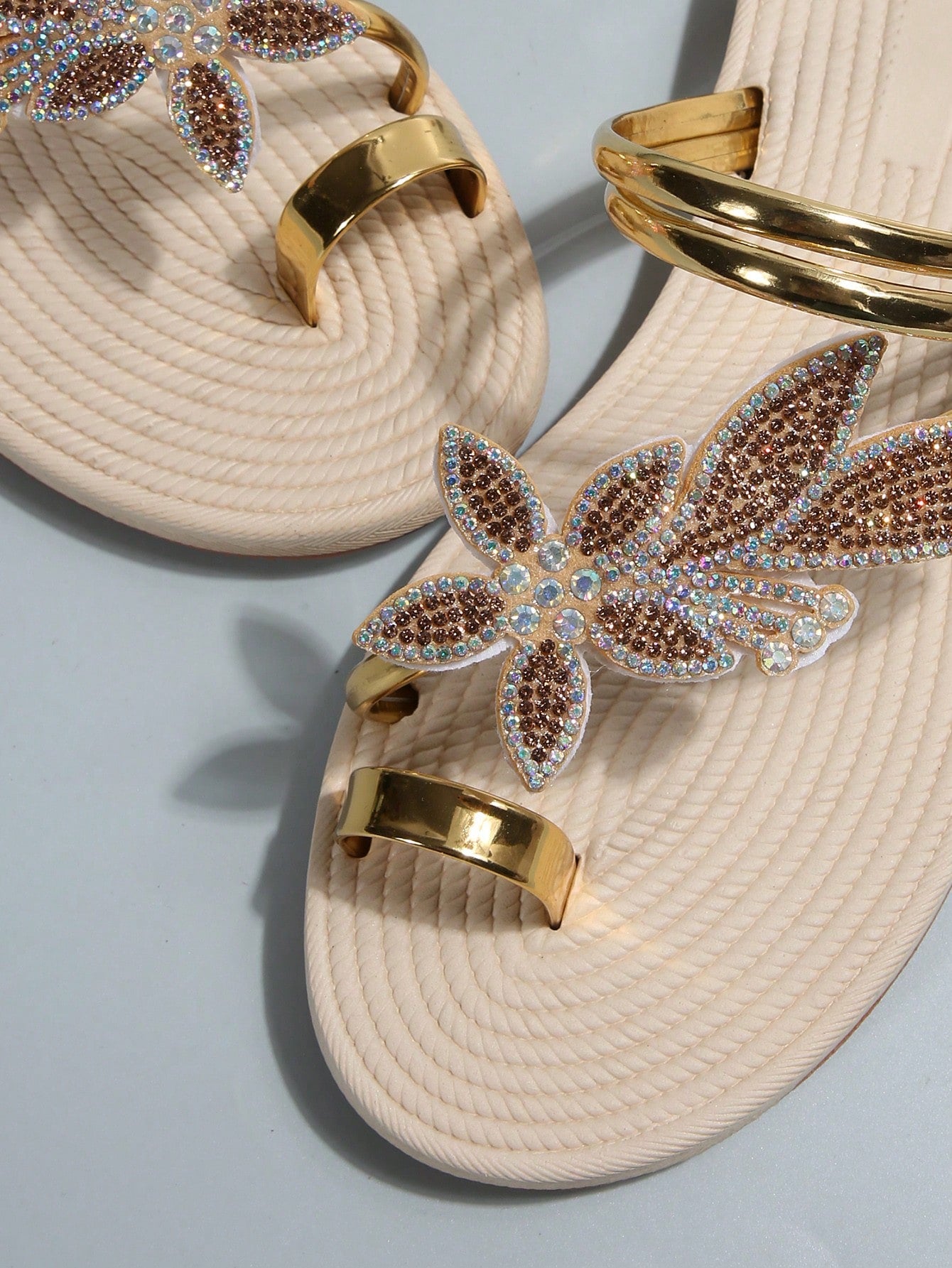 Women's flat slide sandals with crystal-style rhinestone and bow embellishments, toe post front, and beach-ready slip-on design.