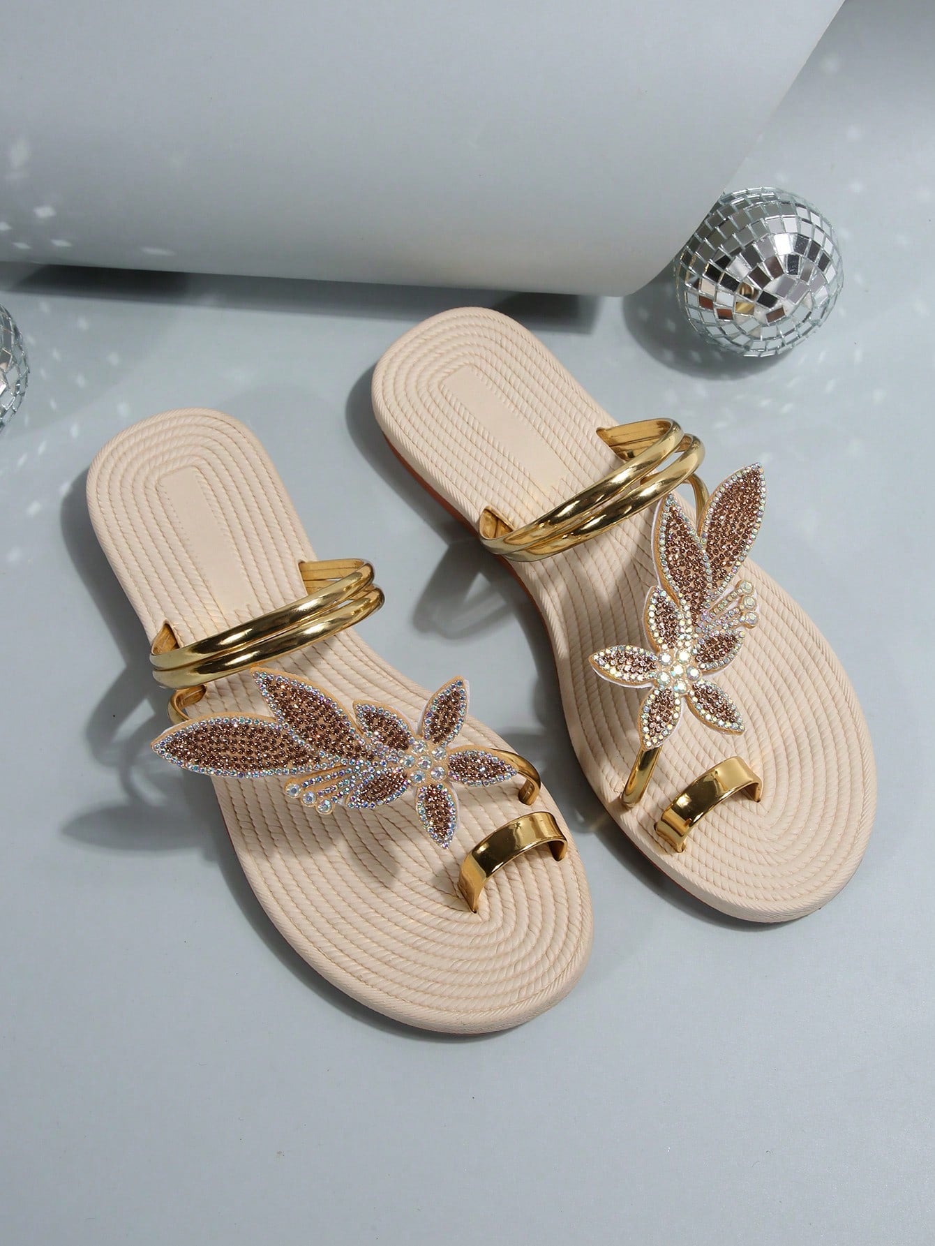 Women's flat slide sandals with crystal-style rhinestone and bow embellishments, toe post front, and beach-ready slip-on design.