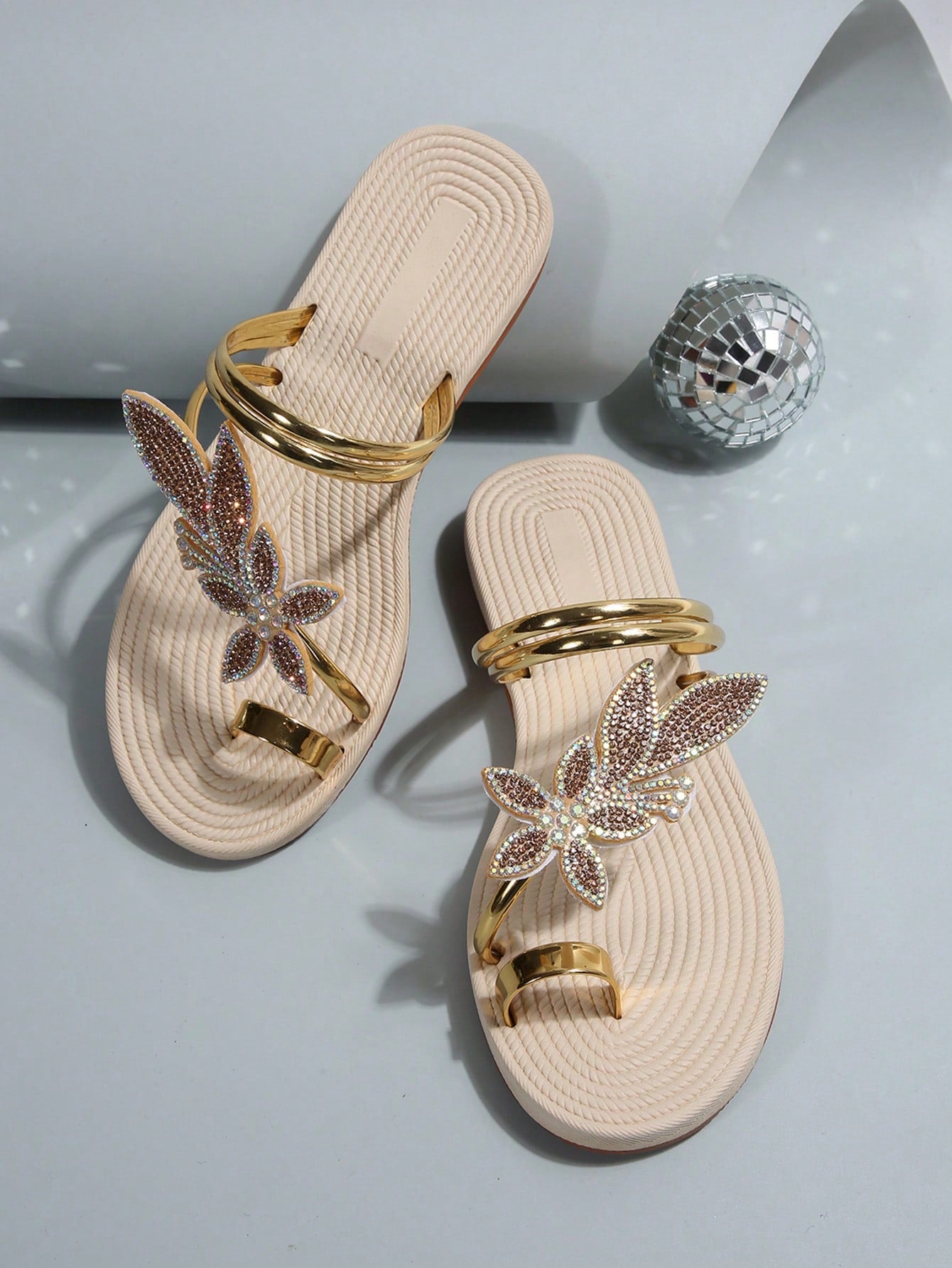 Women's flat slide sandals with crystal-style rhinestone and bow embellishments, toe post front, and beach-ready slip-on design.