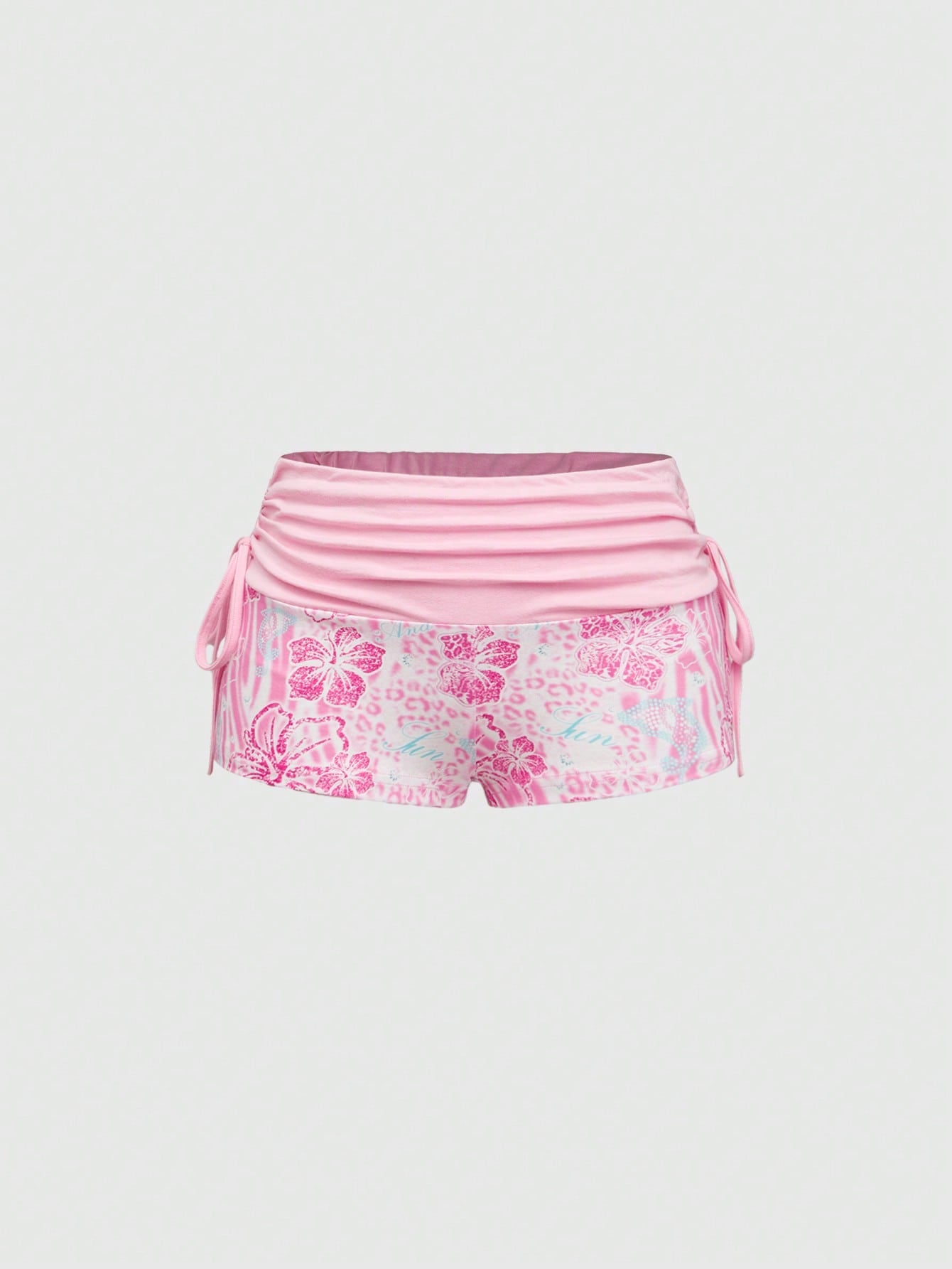Women's low waist mini track shorts with elastic waistband, drawstring knot, ruched details, and plant pattern in a Y2K boho style