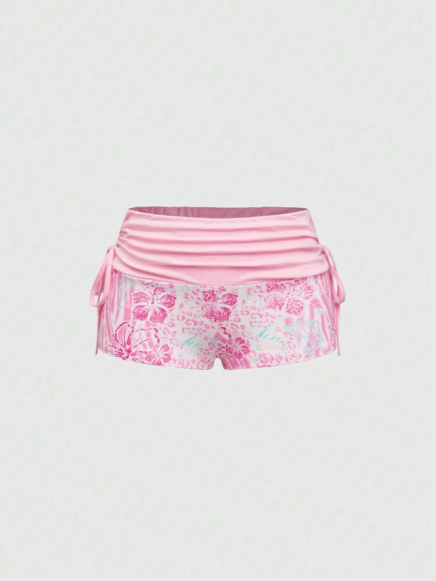 Women's low waist mini track shorts with elastic waistband, drawstring knot, ruched details, and plant pattern in a Y2K boho style