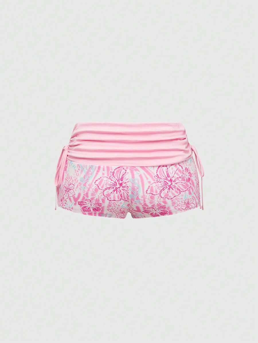 Women's low waist mini track shorts with elastic waistband, drawstring knot, ruched details, and plant pattern in a Y2K boho style