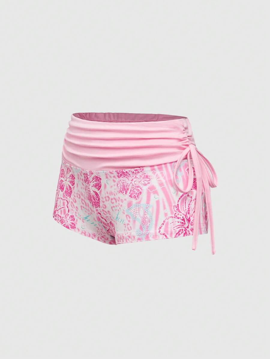 Women's low waist mini track shorts with elastic waistband, drawstring knot, ruched details, and plant pattern in a Y2K boho style