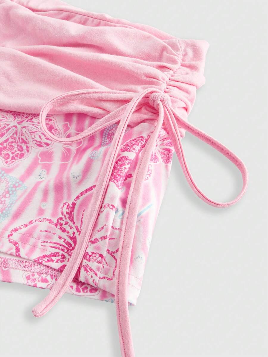 Women's low waist mini track shorts with elastic waistband, drawstring knot, ruched details, and plant pattern in a Y2K boho style