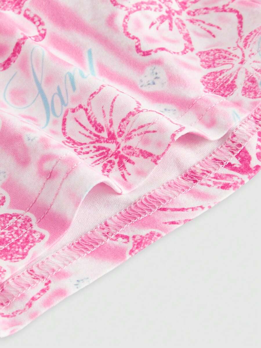 Women's low waist mini track shorts with elastic waistband, drawstring knot, ruched details, and plant pattern in a Y2K boho style