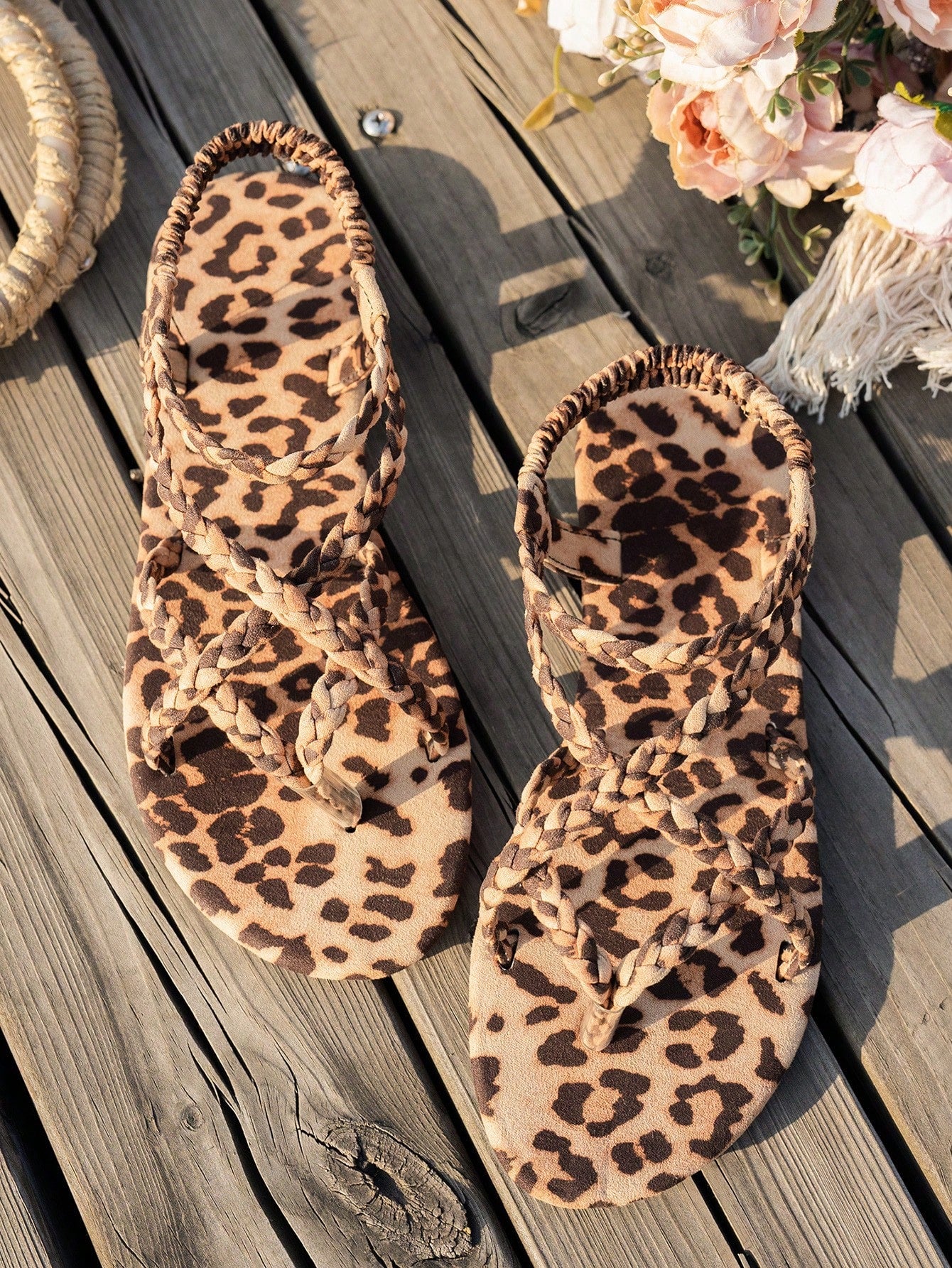 Women’s leopard print woven strap Roman-style flat slide sandals with toe post and cut-out detail.