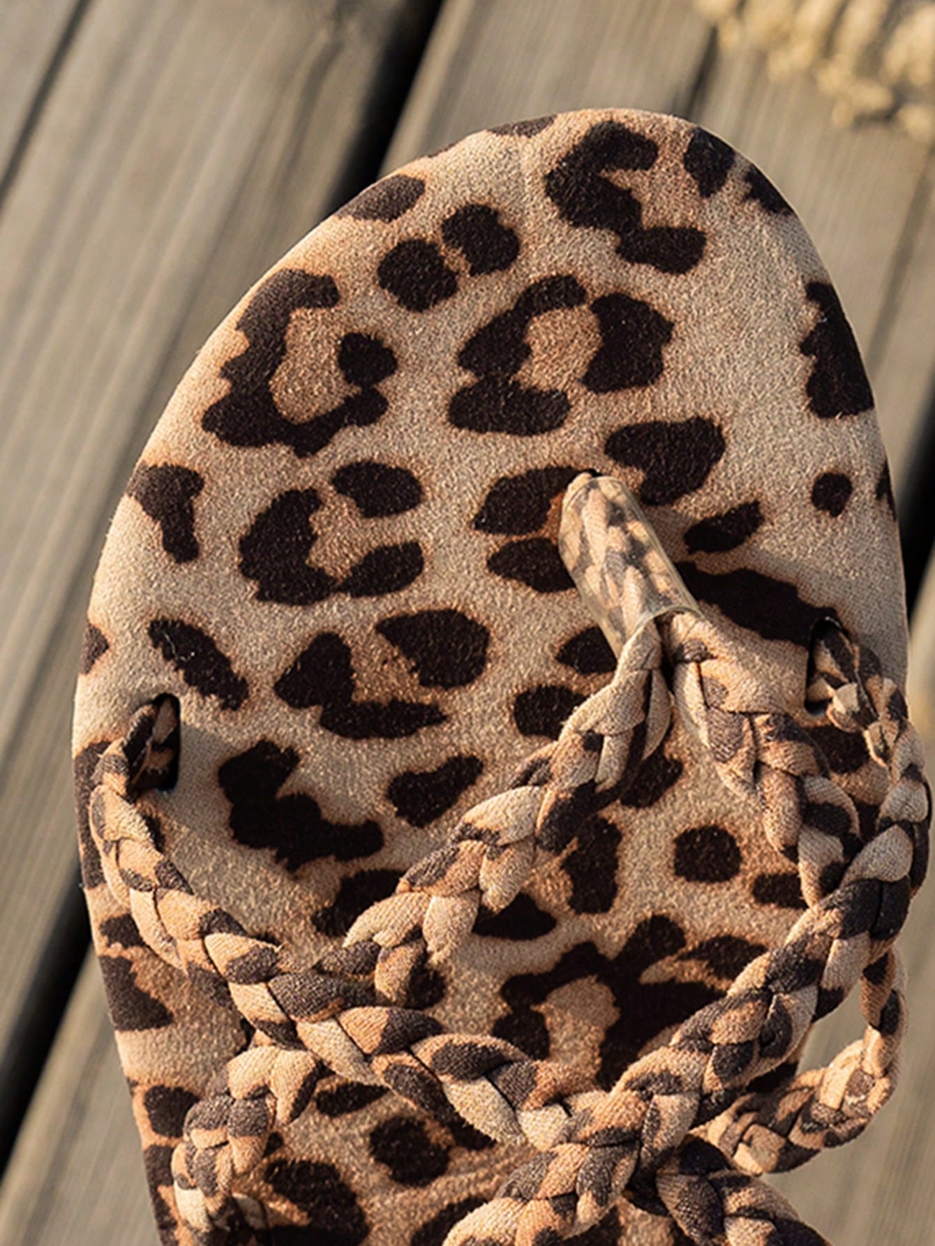 Women’s leopard print woven strap Roman-style flat slide sandals with toe post and cut-out detail.