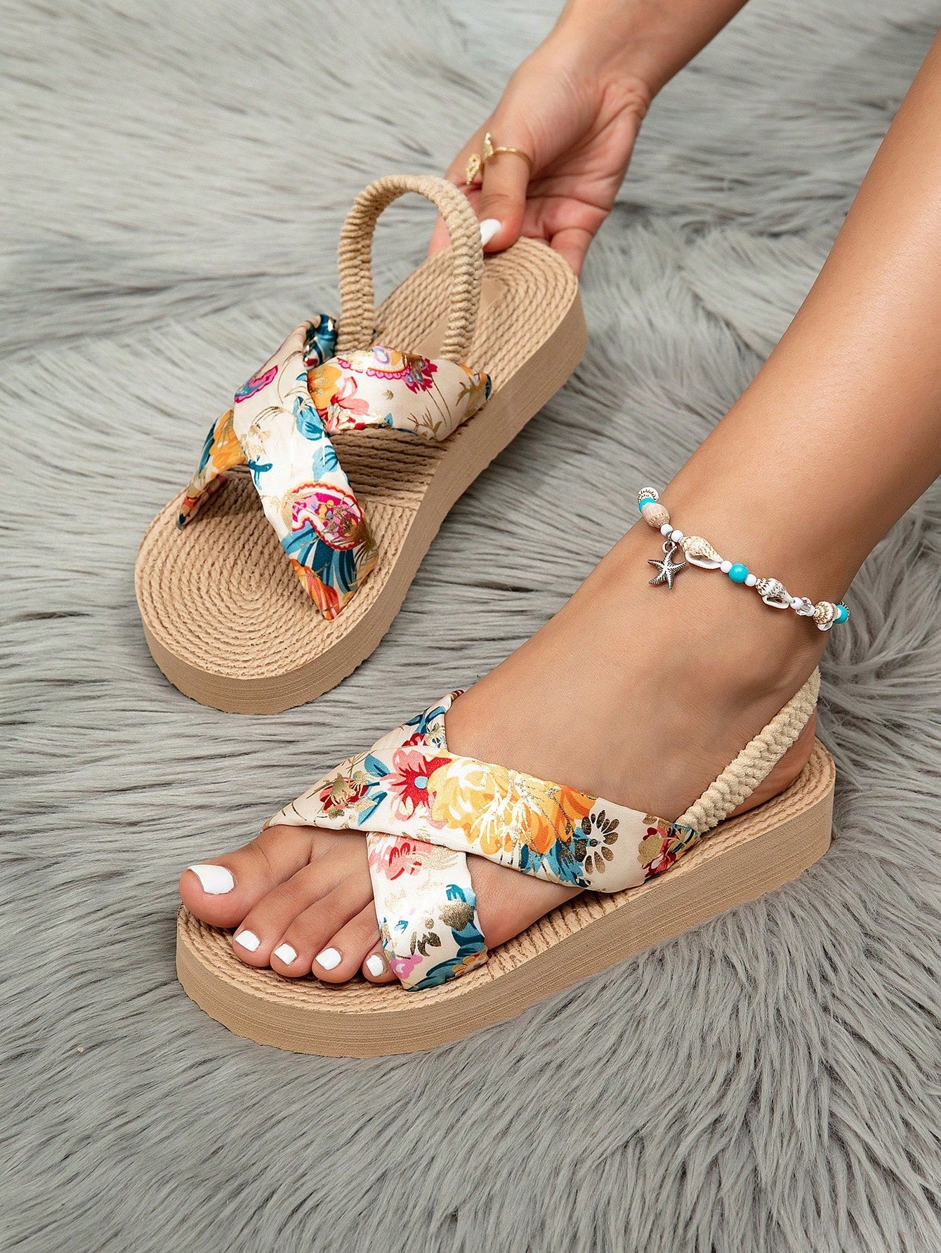 Women's open toe slip-on wedge sandals with criss cross straps and folk-custom styling, featuring raw hem, fringe, tassel, braid, and tape details.