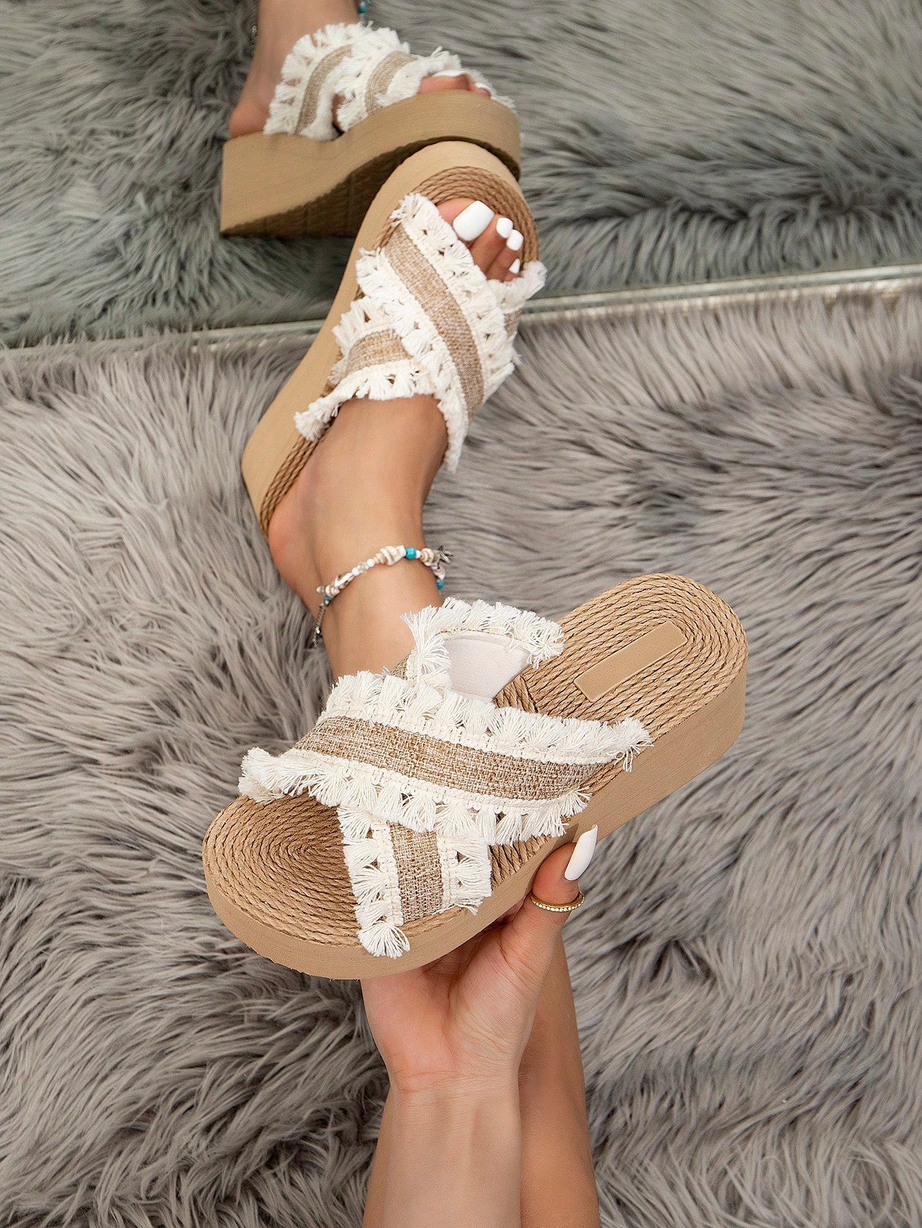 Women's beige slip-on platform wedge slide sandals with open toe, tassel and ruffle details, rope-pattern styling, and mid heel.
