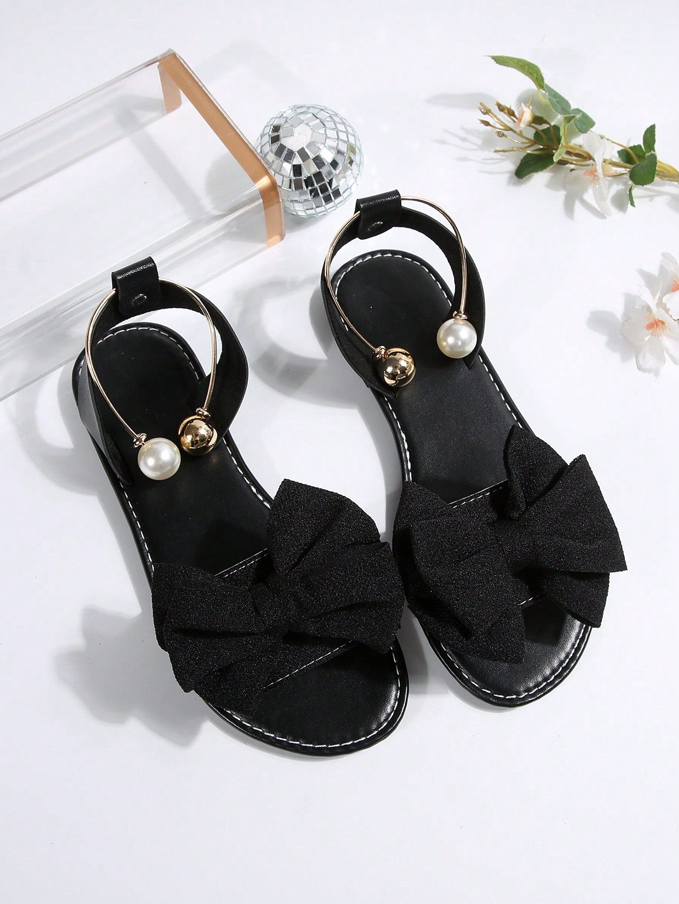Women’s flat open-toe sandals with faux pearl decor and ankle strap design, featuring a microfiber leather upper and beach-ready fashion style.