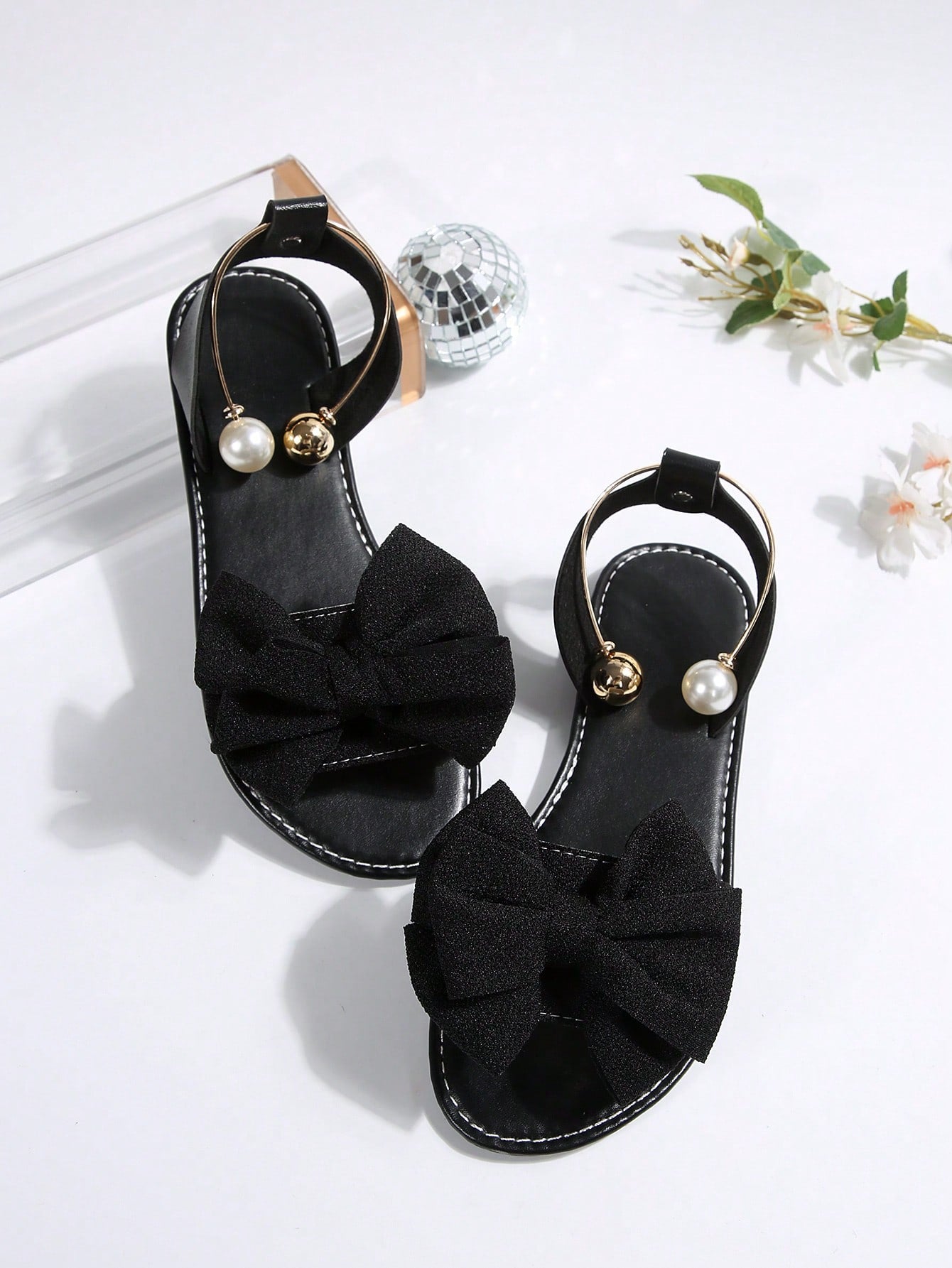 Women’s flat open-toe sandals with faux pearl decor and ankle strap design, featuring a microfiber leather upper and beach-ready fashion style.