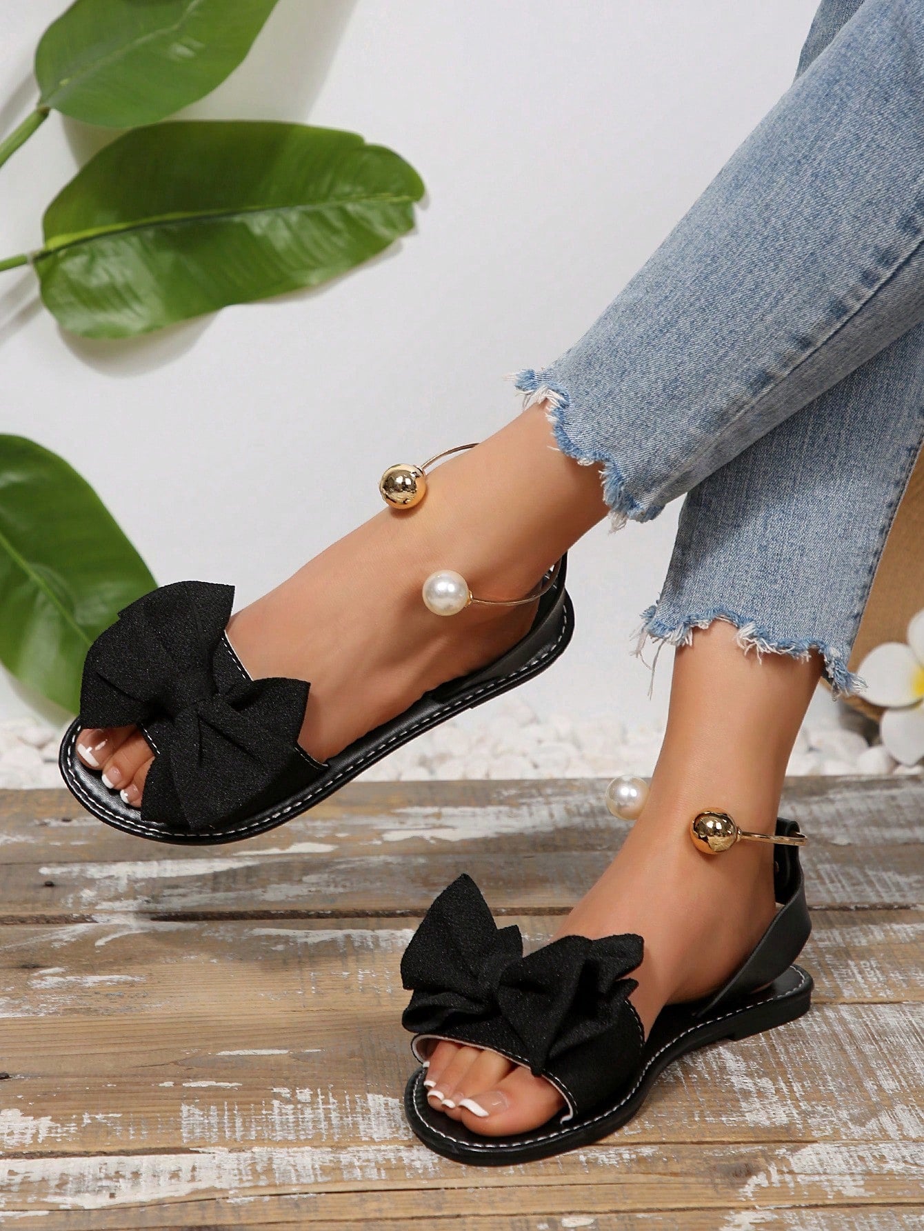 Women’s flat open-toe sandals with faux pearl decor and ankle strap design, featuring a microfiber leather upper and beach-ready fashion style.