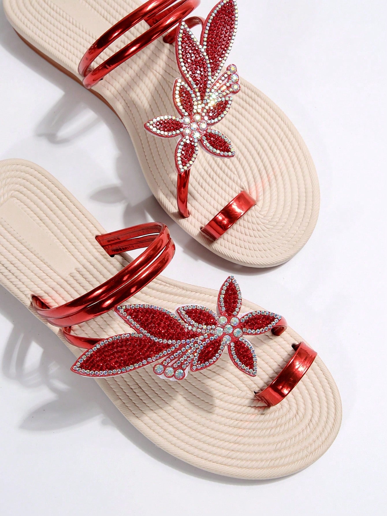 Women's flat slide sandals with crystal-style rhinestone and bow embellishments, toe post front, and beach-ready slip-on design.