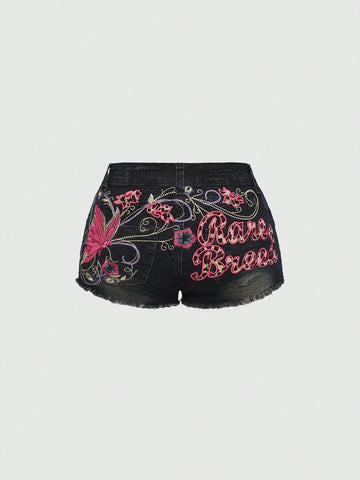 Blue Y2K low waist shorts with butterfly embroidery, distressed washed finish, raw hem, button detail, and zipper fly closure.