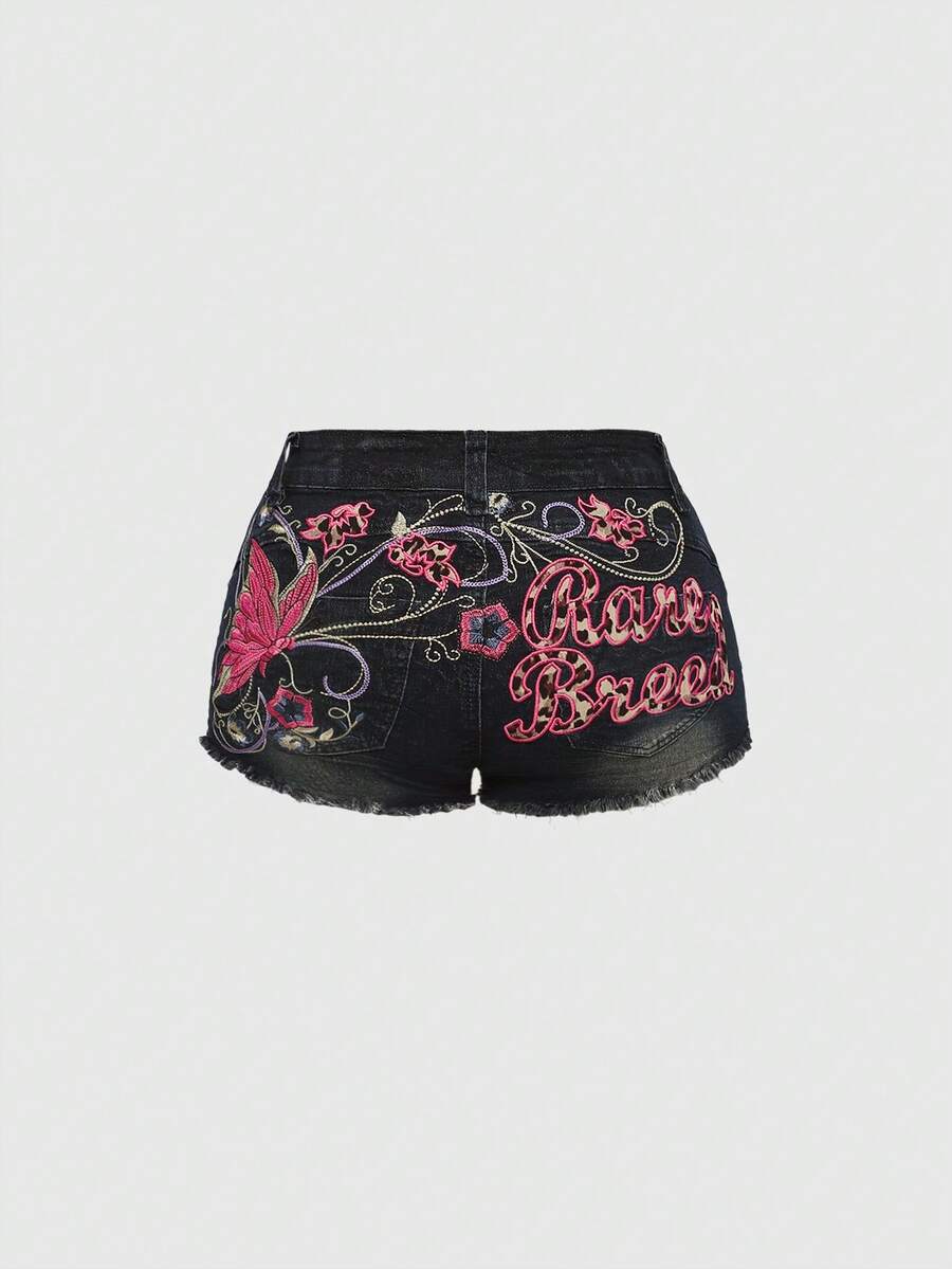 Blue Y2K low waist shorts with butterfly embroidery, distressed washed finish, raw hem, button detail, and zipper fly closure.