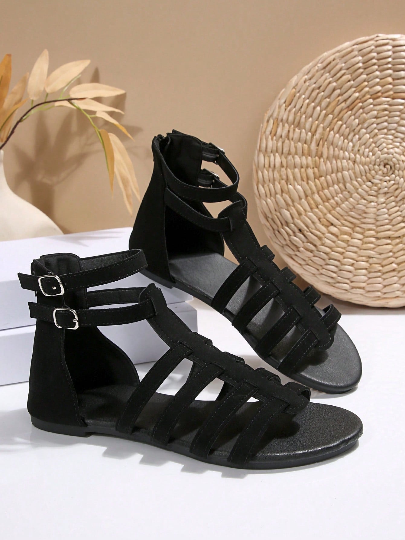 Women’s flat boho gladiator sandals with cross straps, open toe, buckle detail, and back zipper, styled for beach and casual summer wear.