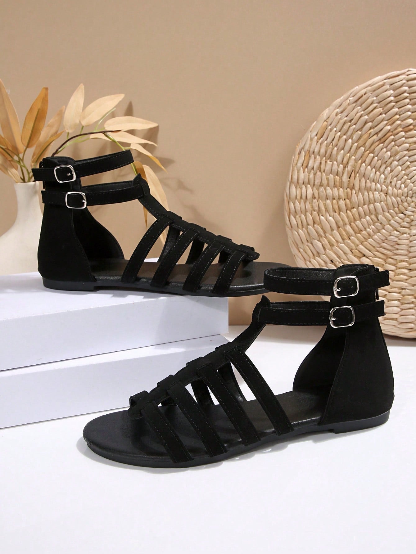 Women’s flat boho gladiator sandals with cross straps, open toe, buckle detail, and back zipper, styled for beach and casual summer wear.
