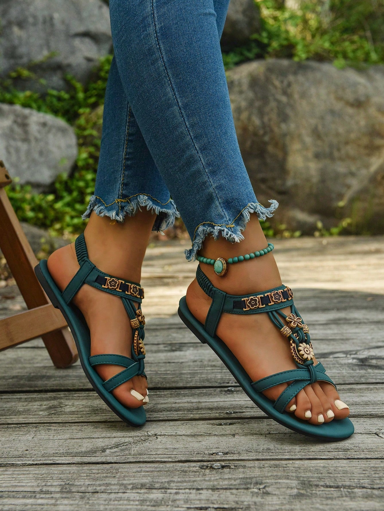 Women's flat slip-on sandals with open toe, plain solid-color look, beaded detail, and golden bar decor in a classic bohemian-inspired style.