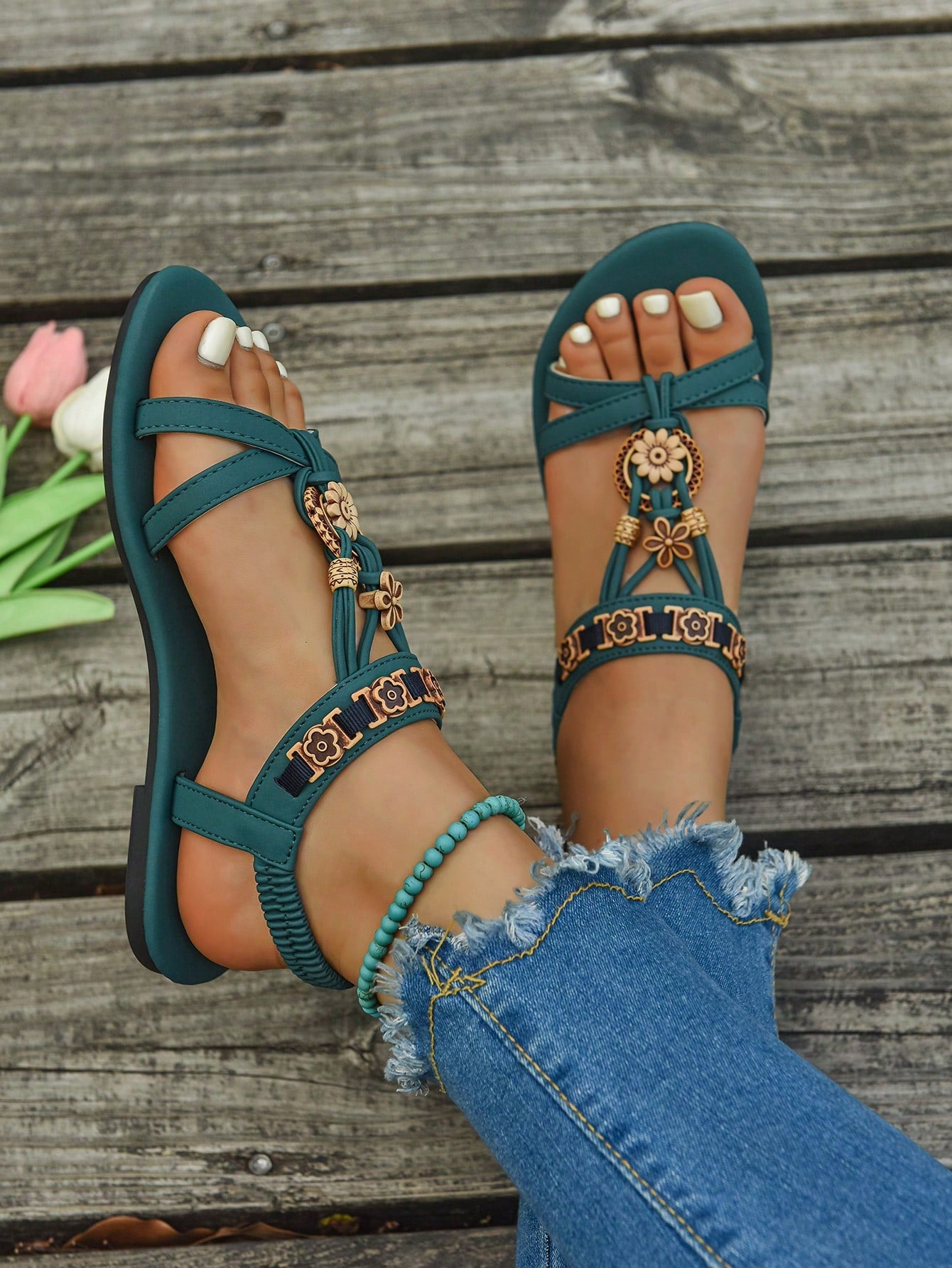 Women's flat slip-on sandals with open toe, plain solid-color look, beaded detail, and golden bar decor in a classic bohemian-inspired style.