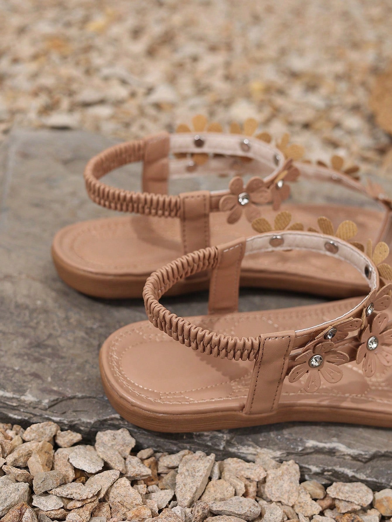 Women's white flat beach thong sandals with toe-post design, featuring flower applique and rhinestone embellishment on the upper, casual summer slide style.