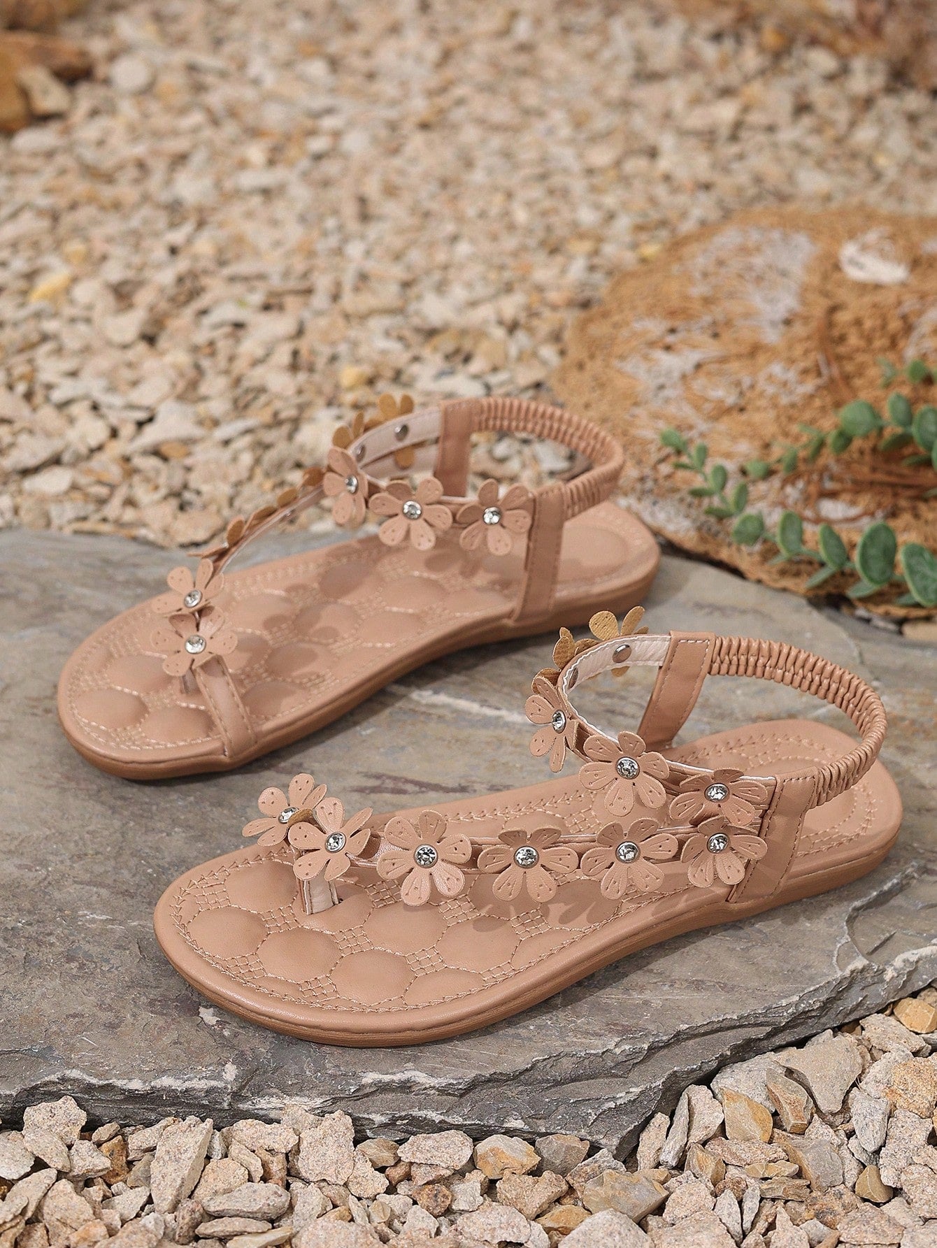 Women's white flat beach thong sandals with toe-post design, featuring flower applique and rhinestone embellishment on the upper, casual summer slide style.