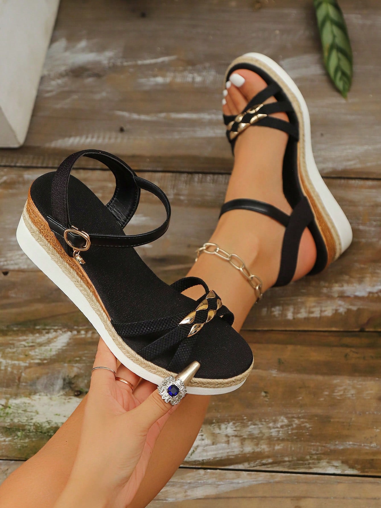 Women’s open-toe wedge sandals with a woven platform-style sole, ankle buckle strap, and mid heel, shown in a casual outdoor style.