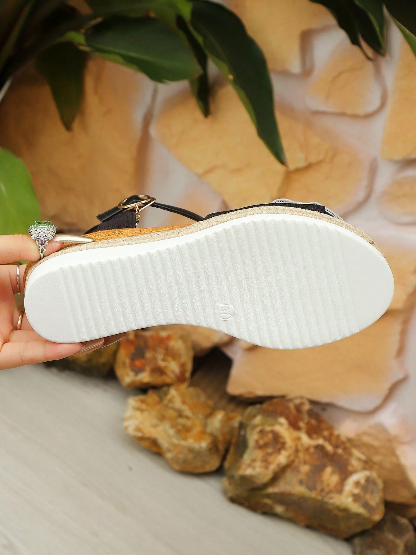 Women’s open-toe wedge sandals with a woven platform-style sole, ankle buckle strap, and mid heel, shown in a casual outdoor style.