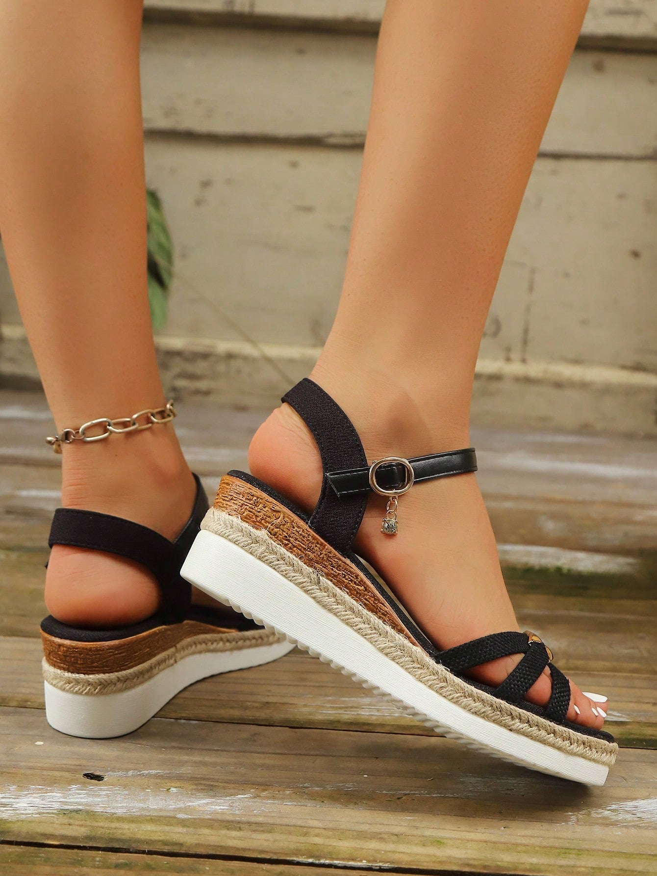 Women’s open-toe wedge sandals with a woven platform-style sole, ankle buckle strap, and mid heel, shown in a casual outdoor style.