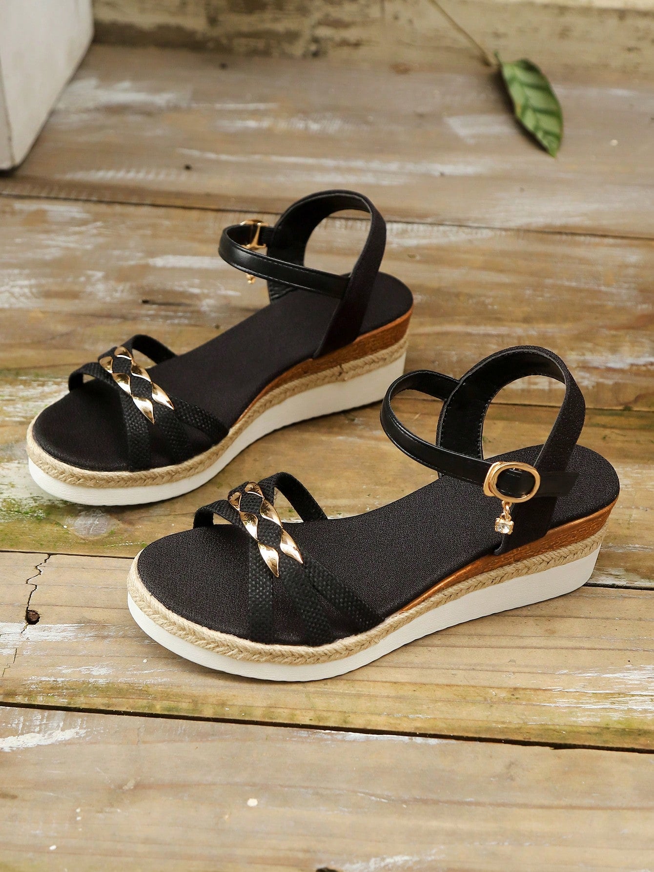 Women’s open-toe wedge sandals with a woven platform-style sole, ankle buckle strap, and mid heel, shown in a casual outdoor style.