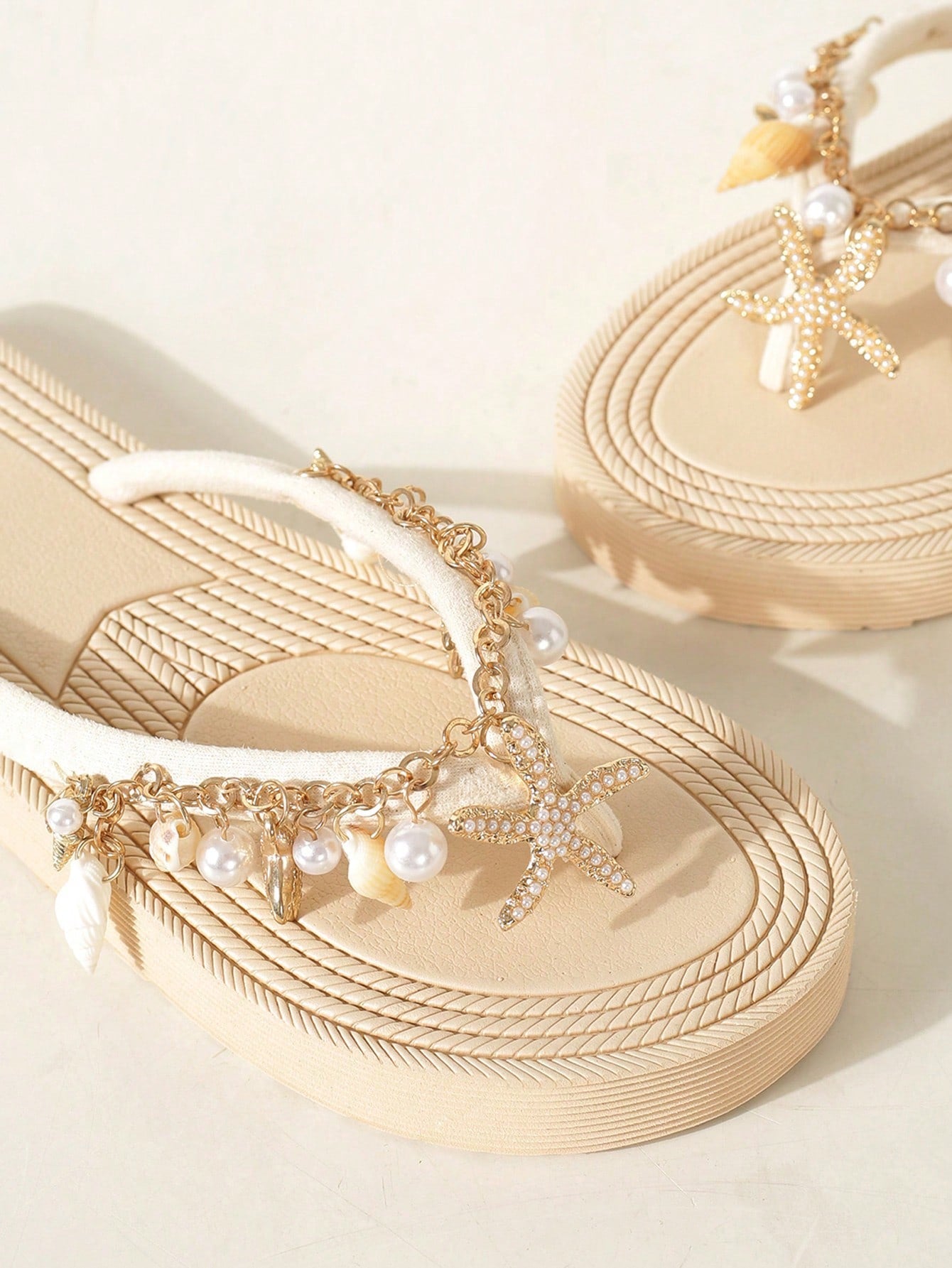 Handmade women’s beach flip flop sandals with shell and starfish rhinestone decorated woven straps, flat thong style, and lightweight non-slip sole.