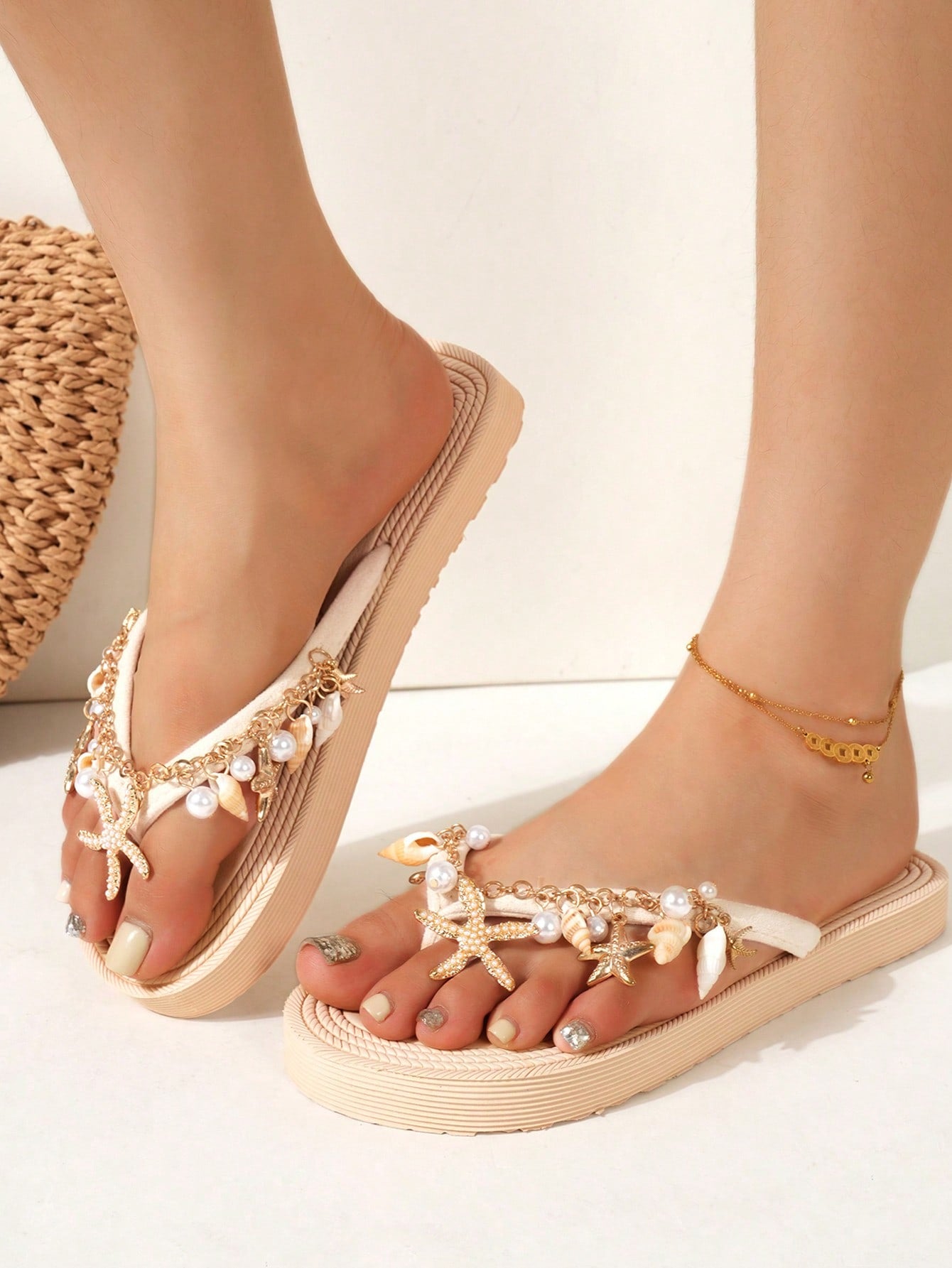 Handmade women’s beach flip flop sandals with shell and starfish rhinestone decorated woven straps, flat thong style, and lightweight non-slip sole.