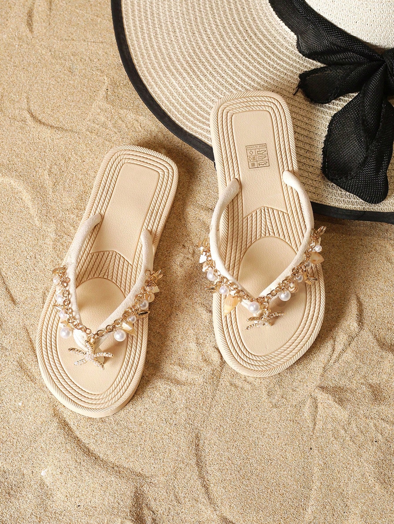 Handmade women’s beach flip flop sandals with shell and starfish rhinestone decorated woven straps, flat thong style, and lightweight non-slip sole.