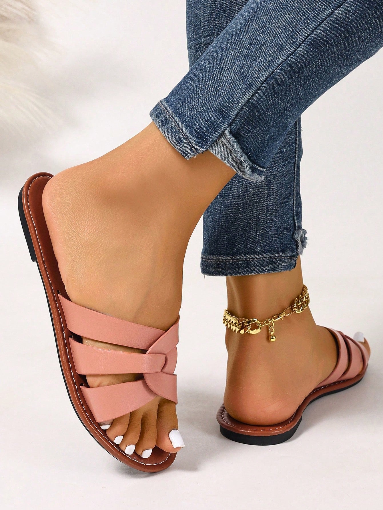 Women’s flat open-toe slide sandals with braided strap detail, embossed texture, and rhinestone decoration, designed as casual slip-on footwear for beach and everyday outdoor wear.
