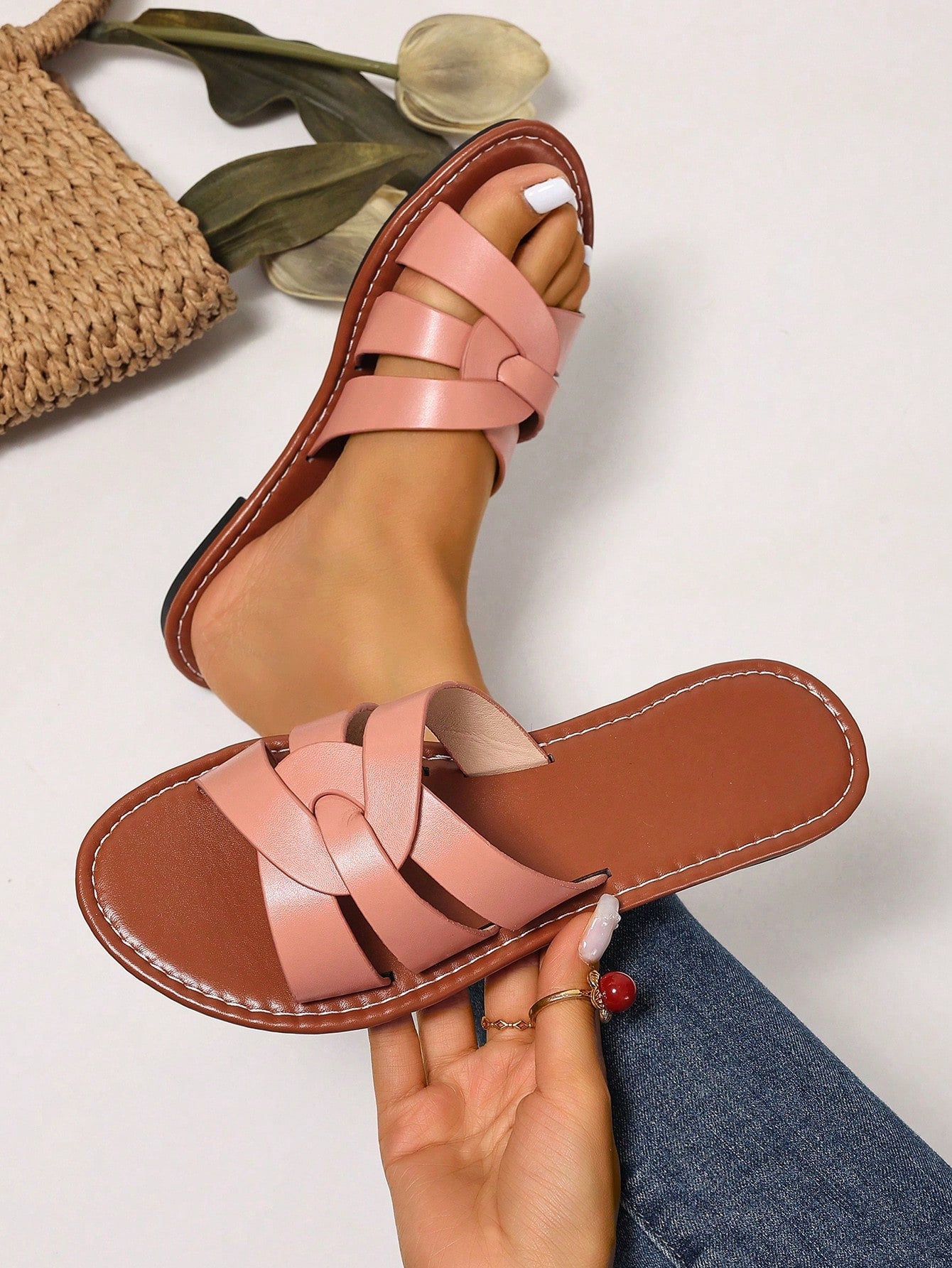 Women’s flat open-toe slide sandals with braided strap detail, embossed texture, and rhinestone decoration, designed as casual slip-on footwear for beach and everyday outdoor wear.