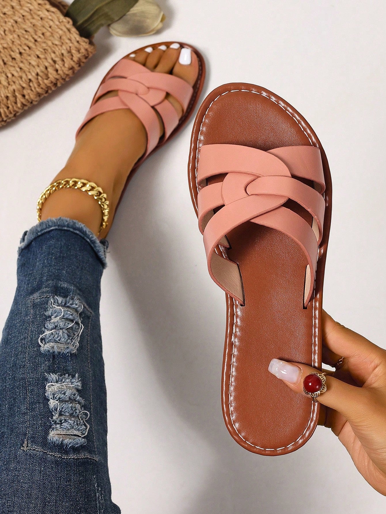 Women’s flat open-toe slide sandals with braided strap detail, embossed texture, and rhinestone decoration, designed as casual slip-on footwear for beach and everyday outdoor wear.
